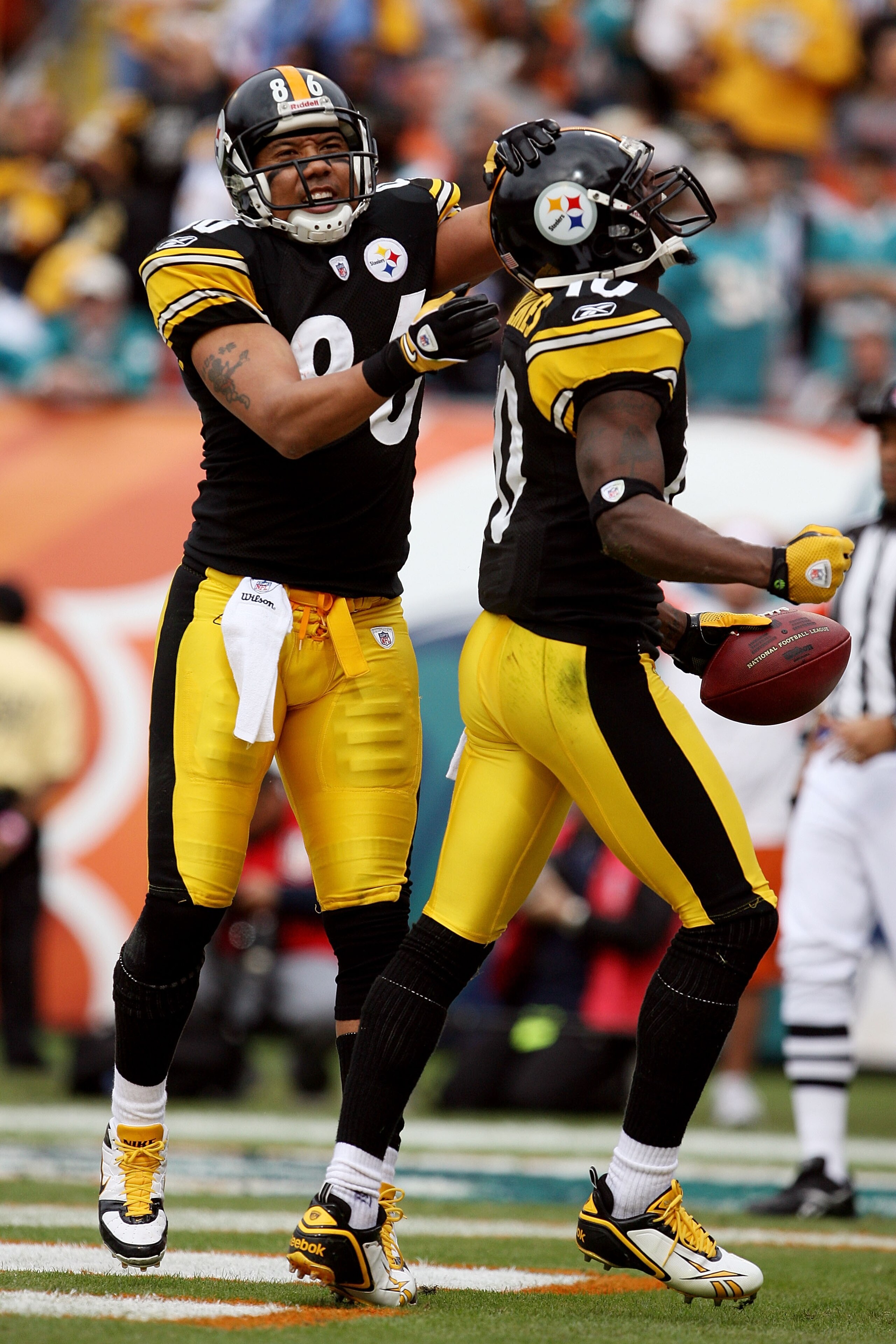 MIAMI - JANUARY 03:  Wide receivers Hines Ward #86 and Santonio Holmes #10 of the Pittsburgh Steelers celebrate after Holmes' touchdown catch in the first quarter against the Miami Dolphins at Land Shark Stadium on January 3, 2010 in Miami, Florida.  (Pho