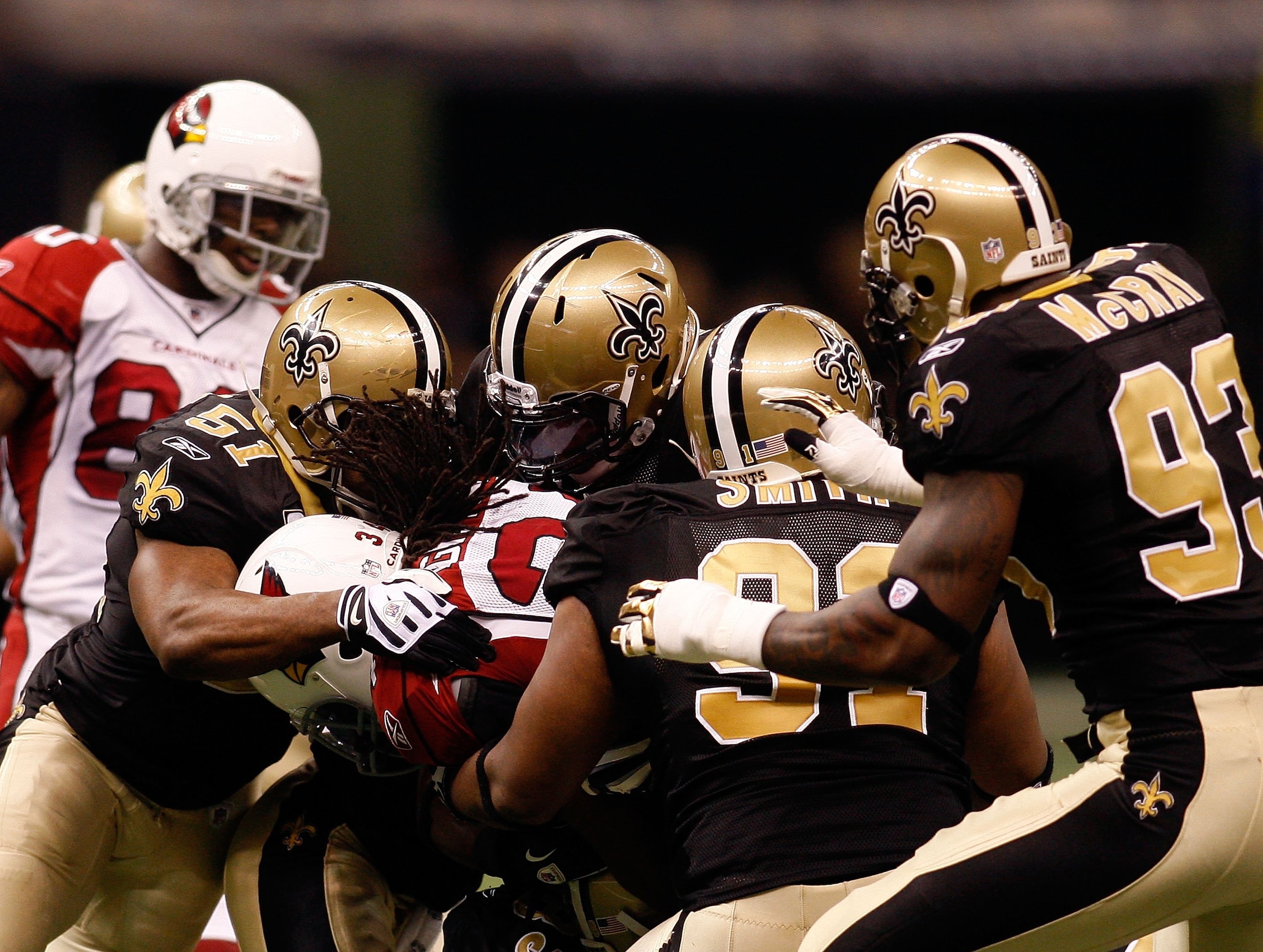 NEW ORLEANS - JANUARY 16:  The New Orleans Saints make a defensive stop against the Arizona Cardinals during the NFC Divisional Playoff Game at Louisana Superdome on January 16, 2010 in New Orleans, Louisiana. The Saints won 45-14. (Photo by Chris Graythe