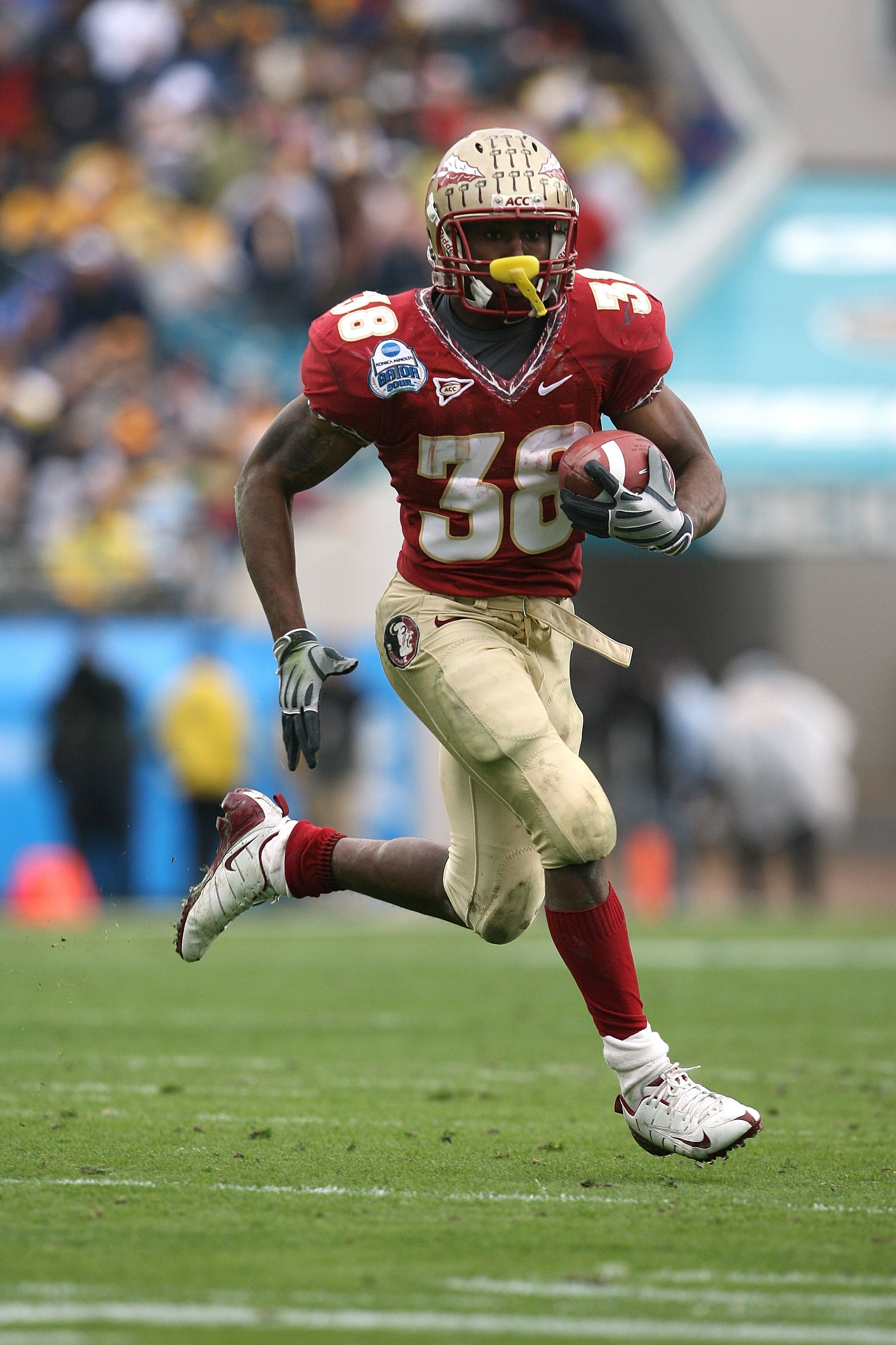 JACKSONVILLE, FL - JANUARY 01:  Running back Jermaine Thomas #38 of the Florida State Seminoles looks for room to run against the West Virginia Mountaineers during the Konica Minolta Gator Bowl on January 1, 2010 at Jacksonville Municipal Stadium in Jacks