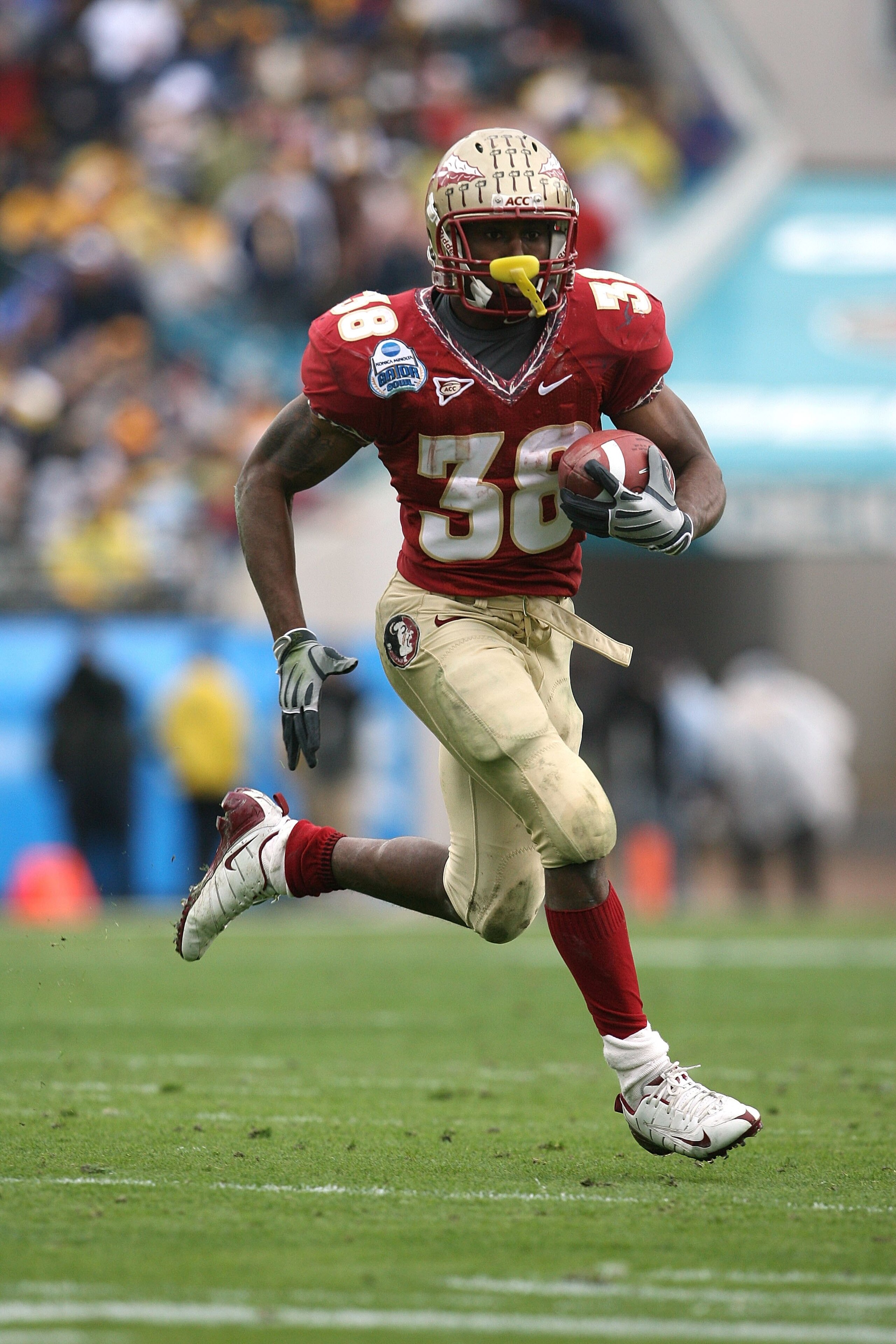 JACKSONVILLE, FL - JANUARY 01:  Running back Jermaine Thomas #38 of the Florida State Seminoles looks for room to run against the West Virginia Mountaineers during the Konica Minolta Gator Bowl on January 1, 2010 at Jacksonville Municipal Stadium in Jacks