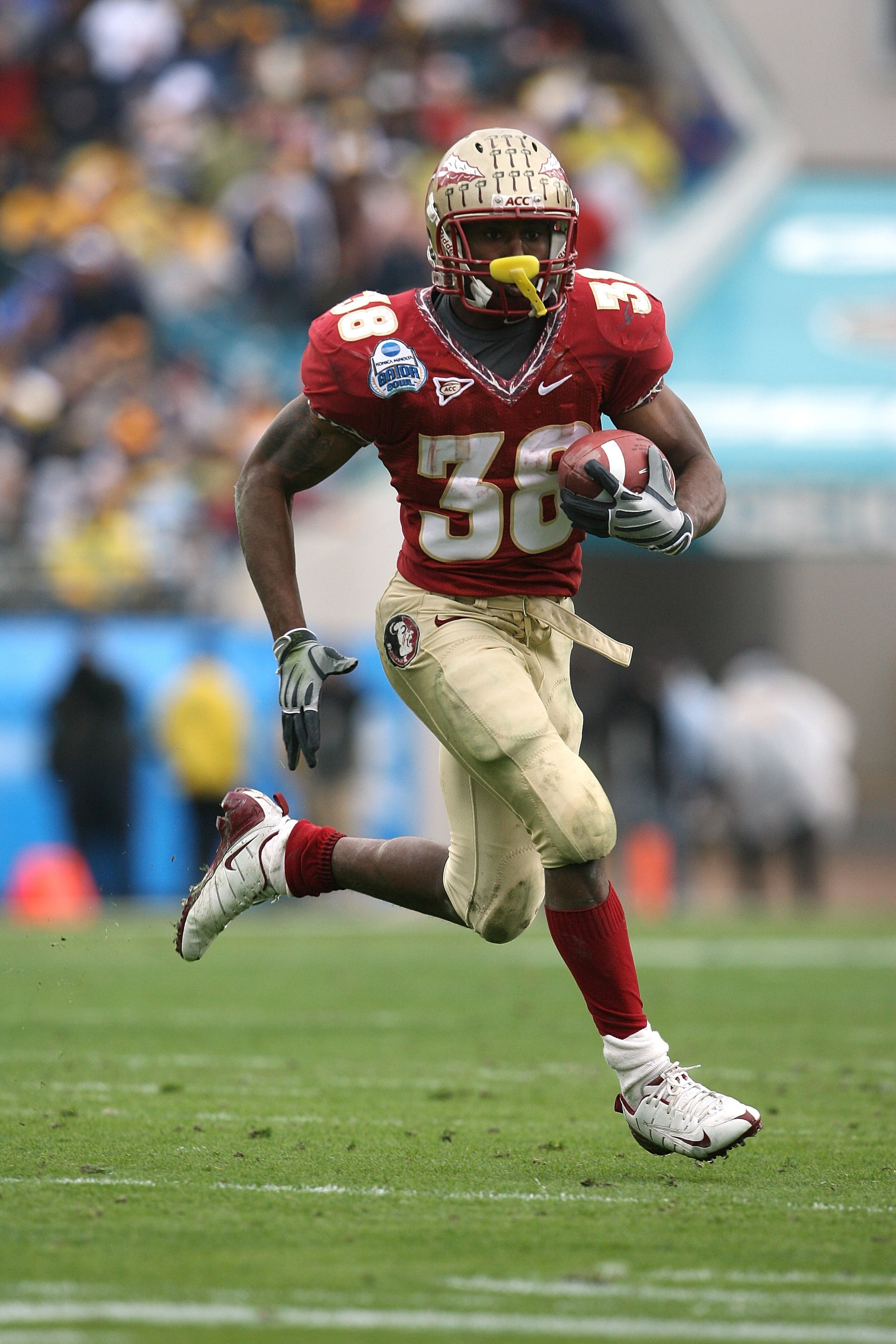 JACKSONVILLE, FL - JANUARY 01:  Running back Jermaine Thomas #38 of the Florida State Seminoles looks for room to run against the West Virginia Mountaineers during the Konica Minolta Gator Bowl on January 1, 2010 at Jacksonville Municipal Stadium in Jacks