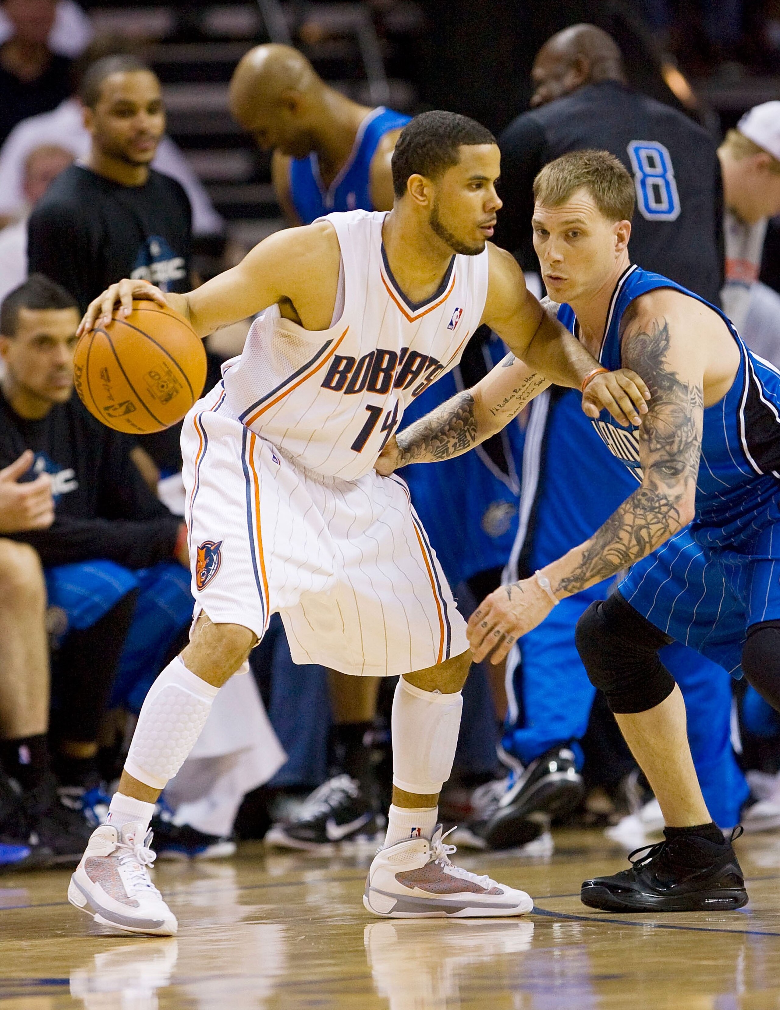 CHARLOTTE, NC - APRIL 26: D.J. Augustin #14 of the Charlotte Bobcats tries to dribble past Jason Williams #44 of the Orlando Magic at Time Warner Cable Arena on April 26, 2010 in Charlotte, North Carolina.  The Magic defeated the Bobcats 99-90 to complete