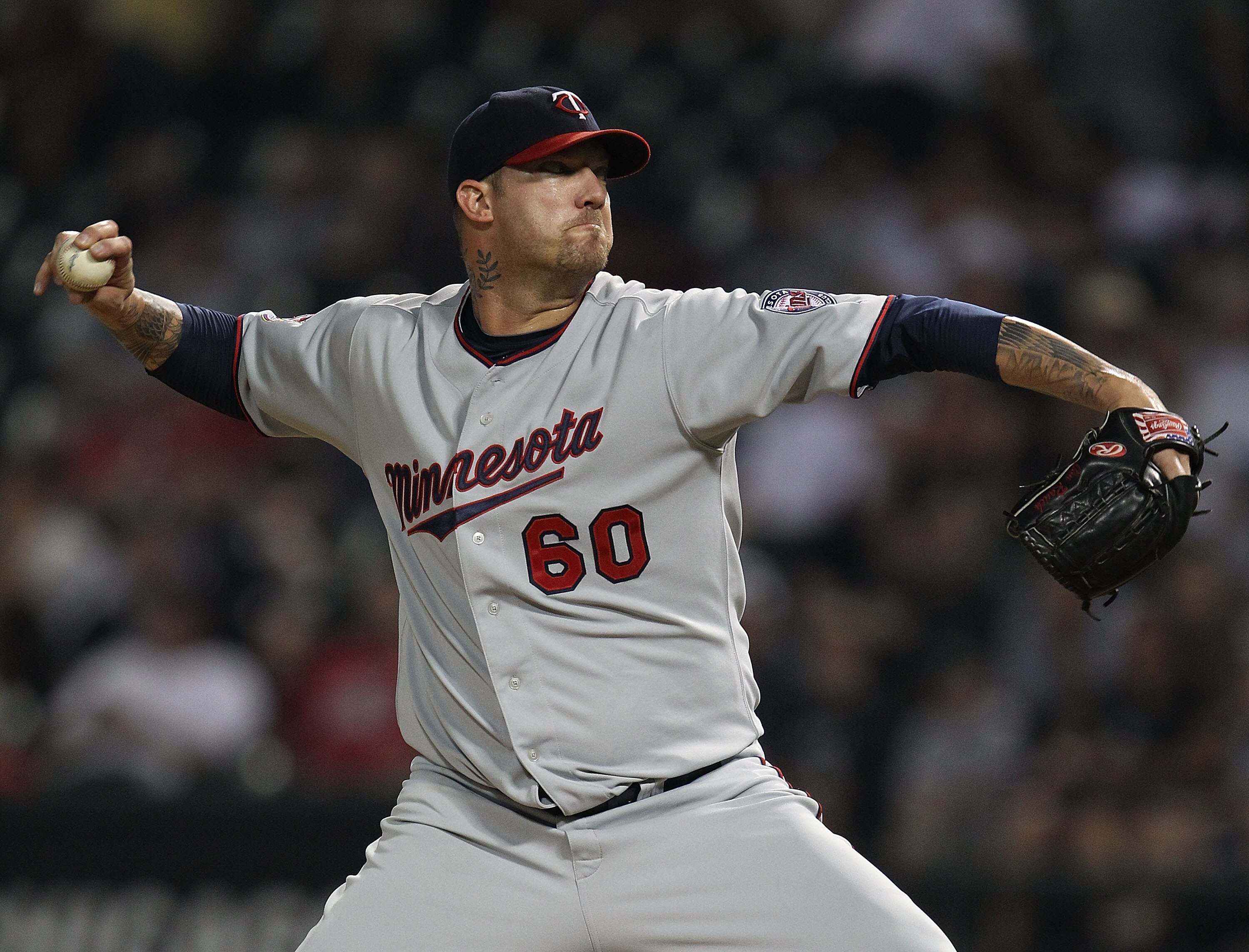 CHICAGO - AUGUST 10: Jon Rauch #60 of the Minnesota Twins pitches in the 9th inning against the Chicago White Sox at U.S. Cellular Field on August 10, 2010 in Chicago, Illinois. The Twins defeated the White Sox 12-6. (Photo by Jonathan Daniel/Getty Images
