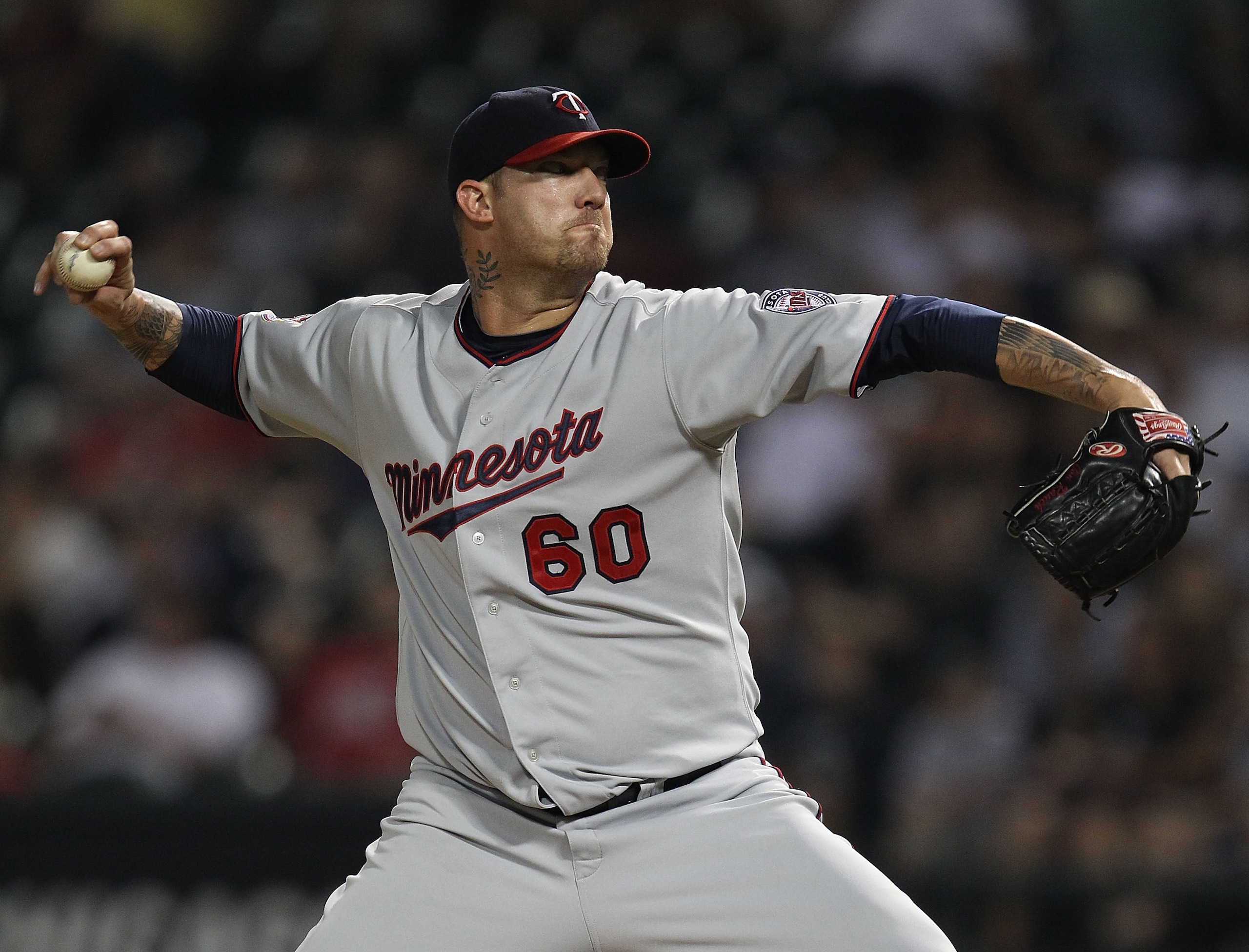 CHICAGO - AUGUST 10: Jon Rauch #60 of the Minnesota Twins pitches in the 9th inning against the Chicago White Sox at U.S. Cellular Field on August 10, 2010 in Chicago, Illinois. The Twins defeated the White Sox 12-6. (Photo by Jonathan Daniel/Getty Images