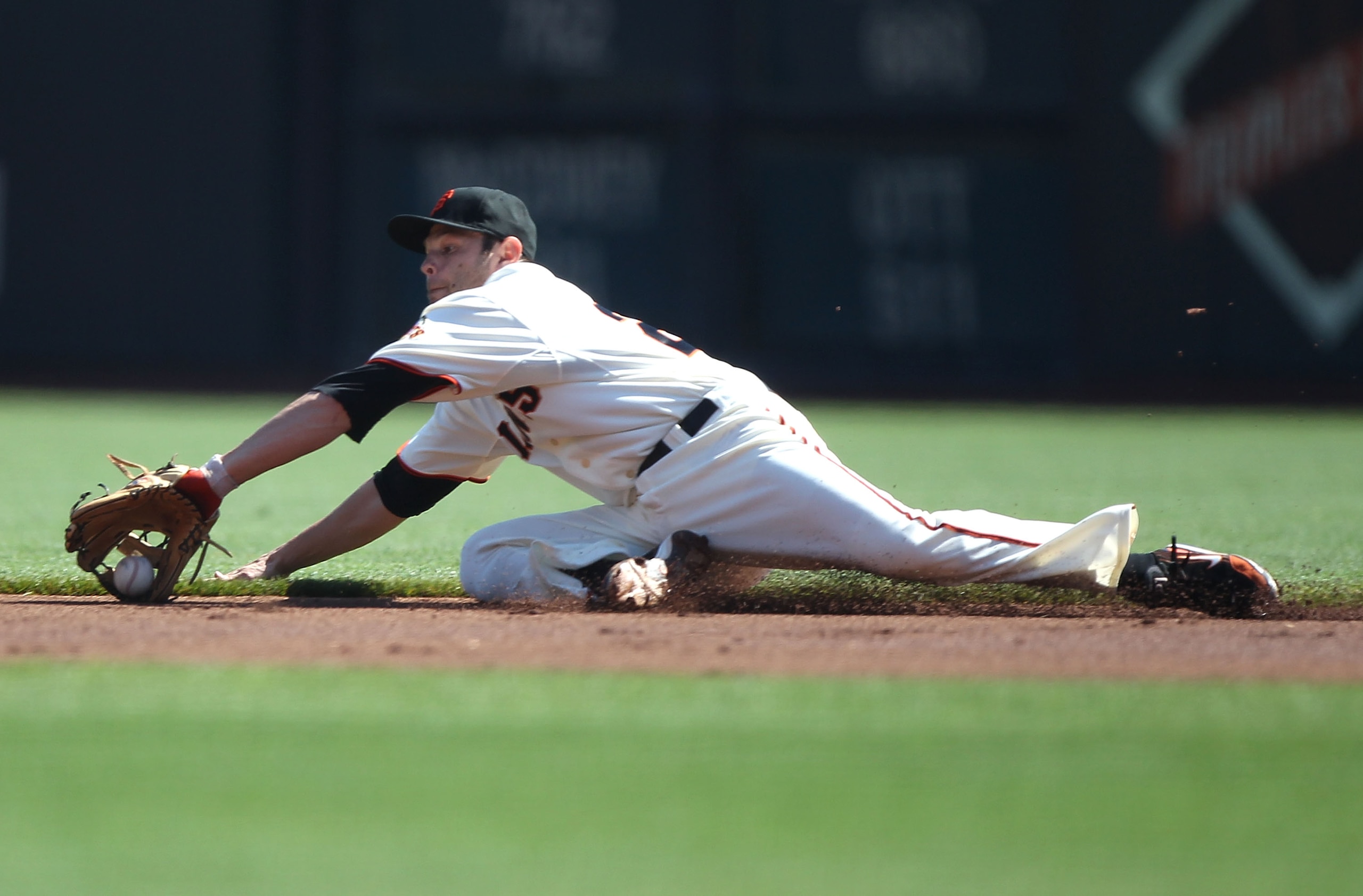SAN FRANCISCO - SEPTEMBER 30:  Freddie Sanchez #21 of the San Francisco Giants can't reach a single hit by Kelly Johnson of the Arizona Diamondbacks in the first inning during a Major League Baseball game at AT&T Park on September 30, 2010 in San Francisc