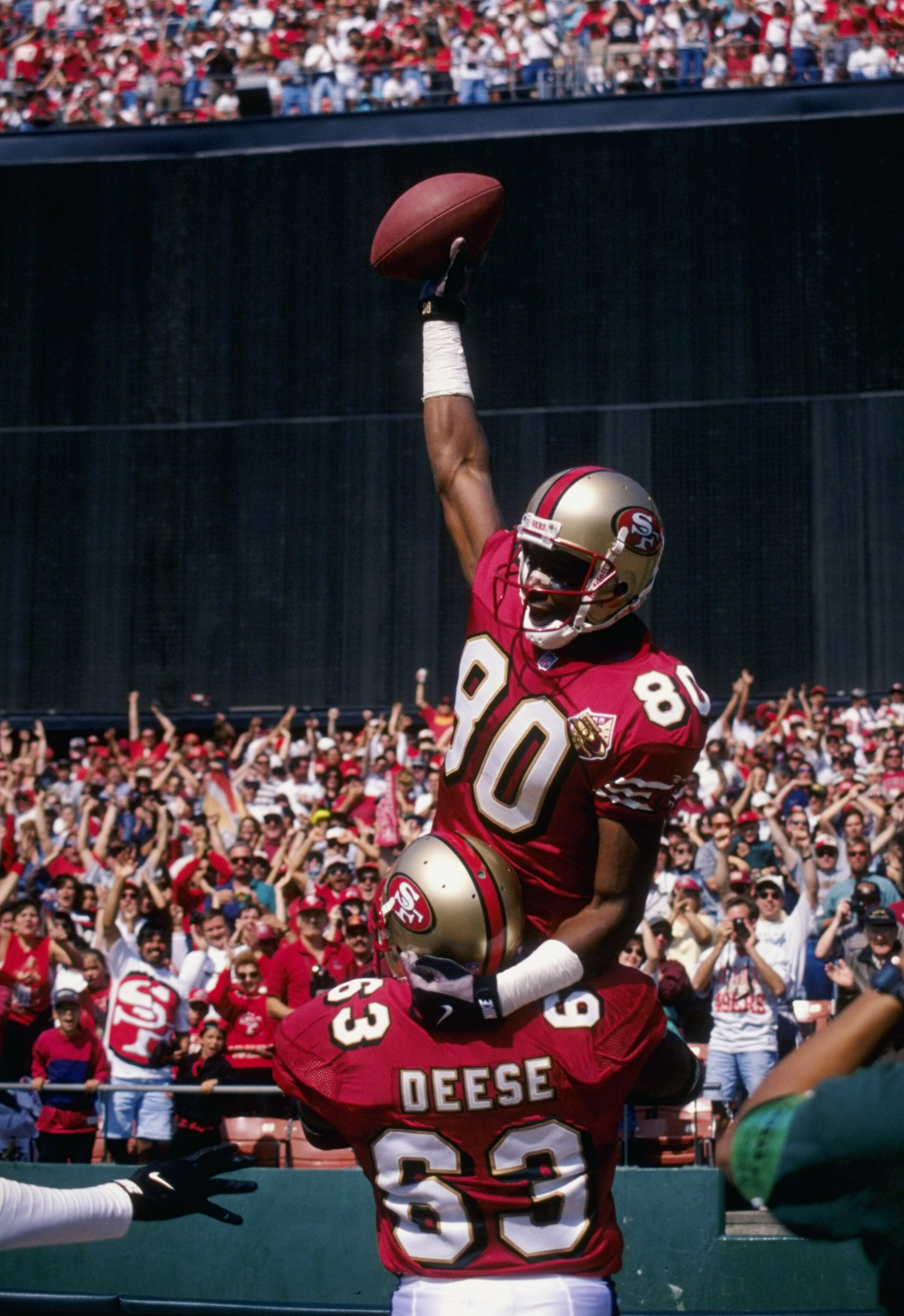 29 Sep 1996:  Jerry Rice #80 of the San Francisco 49ers celebrates with Derrick Deese #63 during their 39-17 victory over the Atlanta Falcons at 3Com Park in San Francisco, California. Mandatory Credit: Otto Greule Jr.  /Allsport