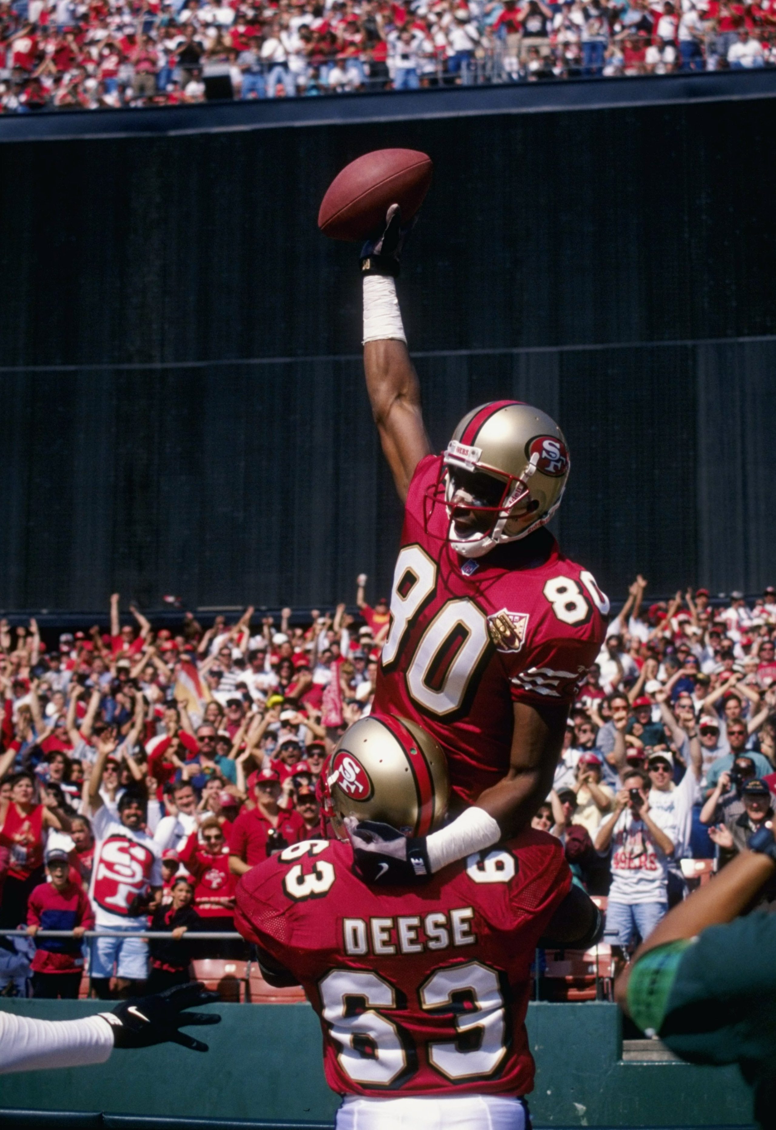 29 Sep 1996:  Jerry Rice #80 of the San Francisco 49ers celebrates with Derrick Deese #63 during their 39-17 victory over the Atlanta Falcons at 3Com Park in San Francisco, California. Mandatory Credit: Otto Greule Jr.  /Allsport