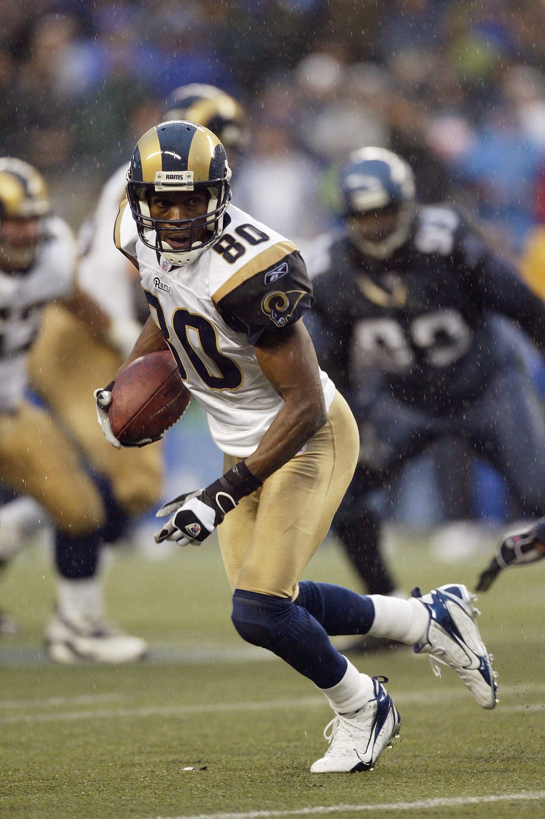 SEATTLE - NOVEMBER 12:  Wide receiver Isaac Bruce #80 of the St. Louis Rams runs with the ball during the NFL game against the Seattle Seahawks at Qwest Field on November 12, 2006 in Seattle, Washington. The Seahawks won 24-22. (Photo by Otto Greule Jr/Ge