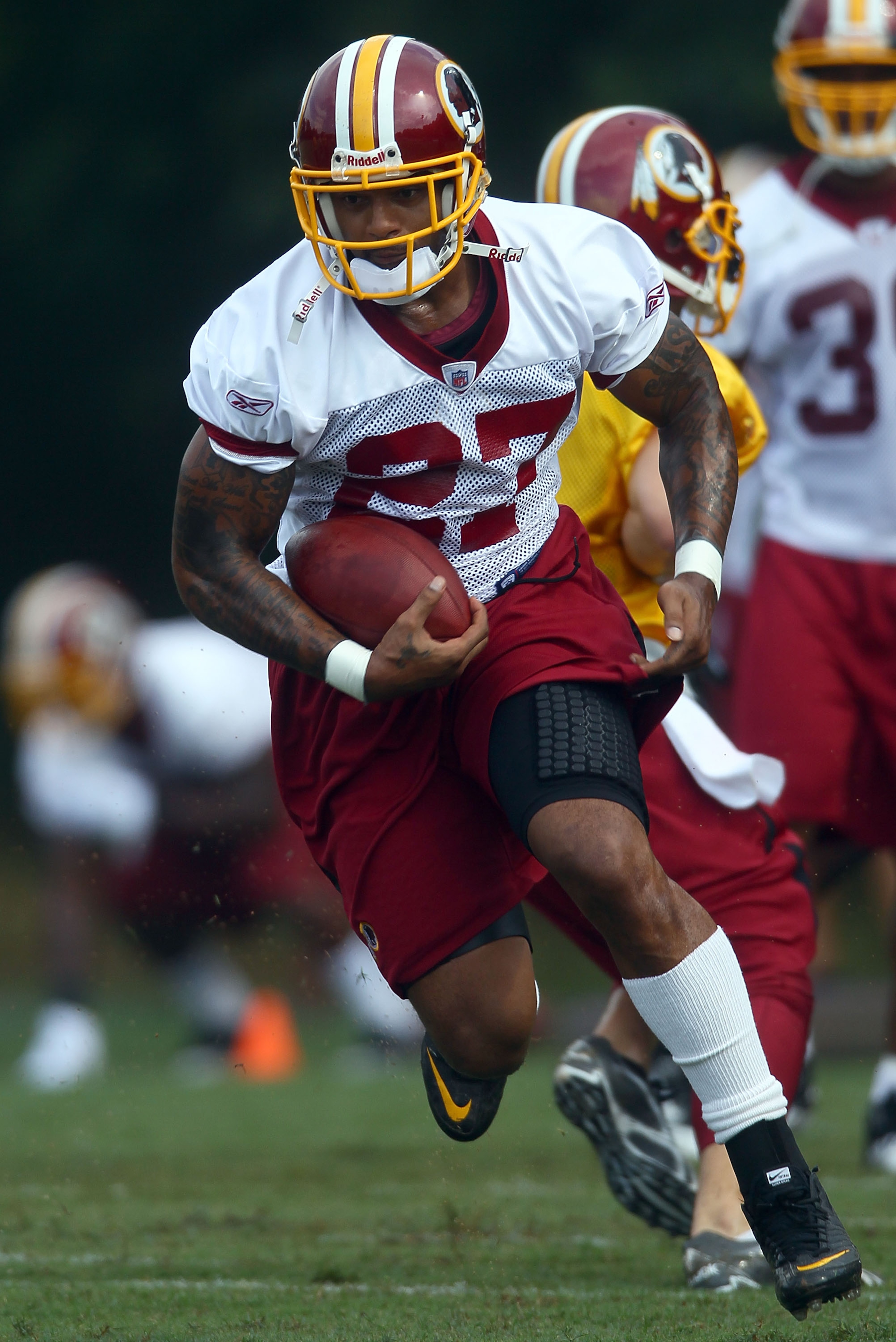 ASHBURN, VA - JULY 29:  Running back Larry Johnson #27 of the Washington Redskins carries the ball during drills on the first day of training camp July 29, 2010 in Ashburn, Virginia.  (Photo by Win McNamee/Getty Images)
