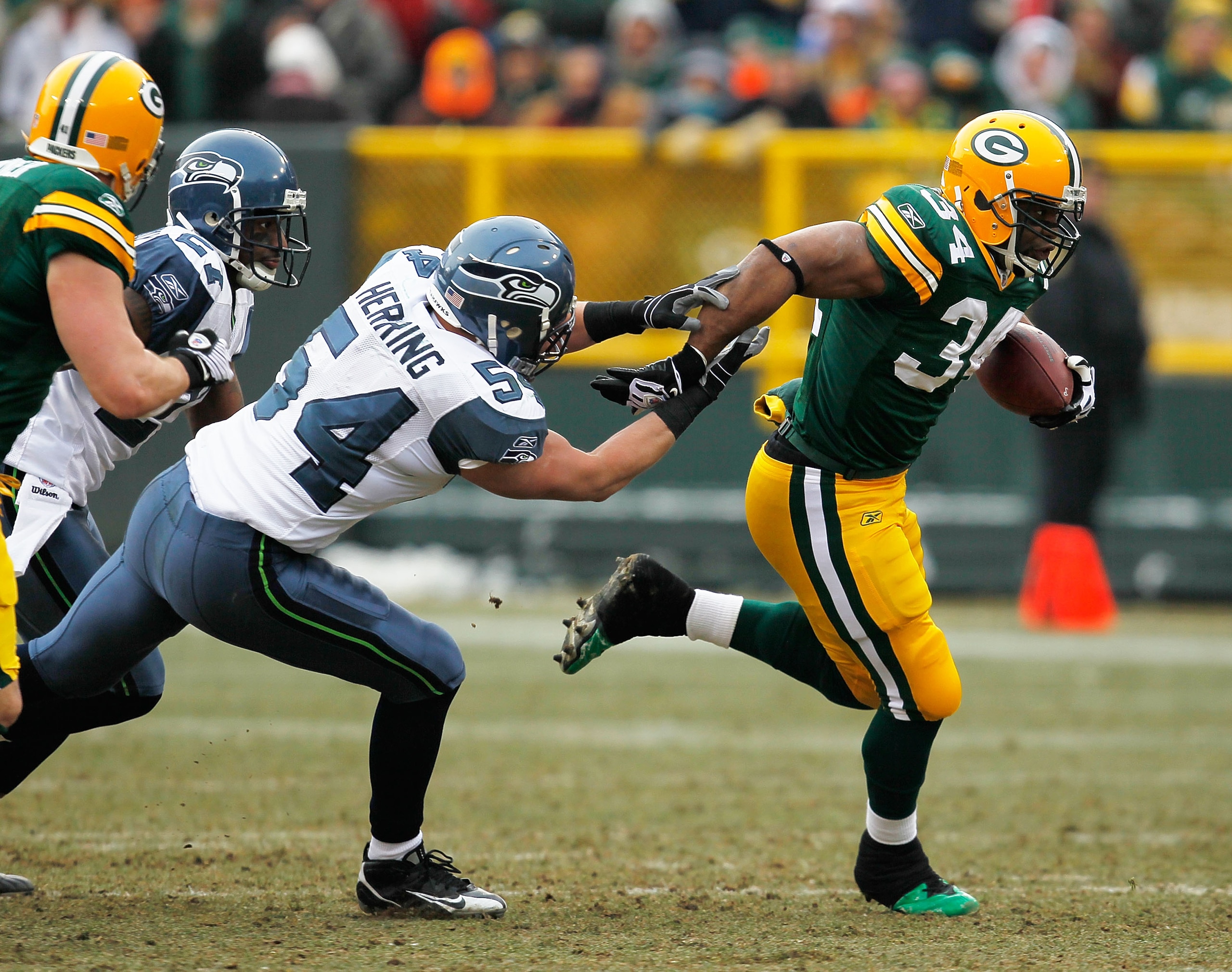 GREEN BAY, WI - DECEMBER 27: Ahman Green #34 of the Green Bay Packers breaks away from Will Herring #54 of the Seattle Seahawks at Lambeau Field on December 27, 2009 in Green Bay, Wisconsin. The Packers defeated the Seahawks 48-10.  (Photo by Jonathan Dan
