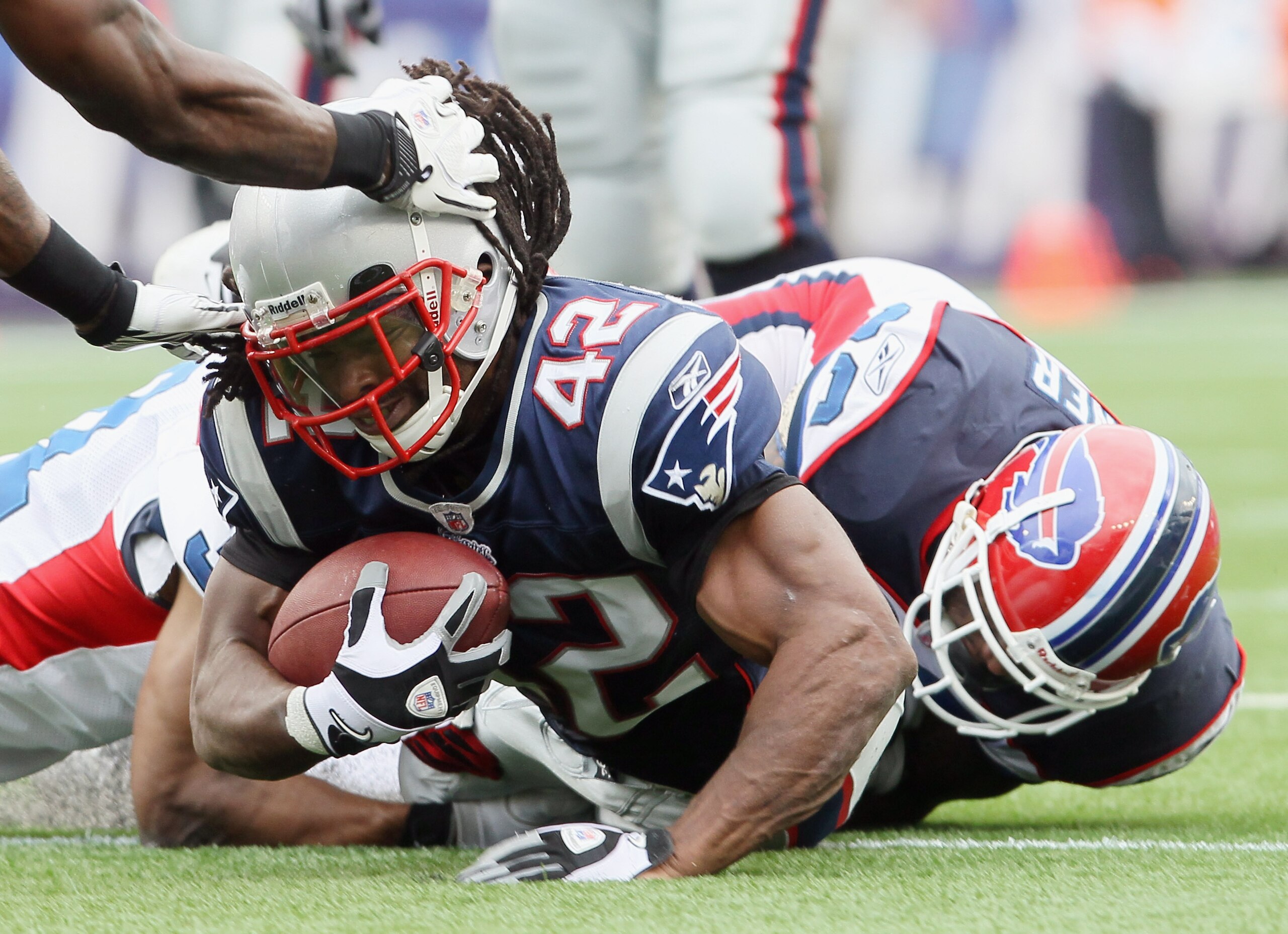 FOXBORO, MA - SEPTEMBER 26:  BenJarvus Green-Ellis #42 of the New England Patriots is brought down by Donte Whitner #20 of the Buffalo Bills during on September 26, 2010 at Gillette Stadium in Foxboro, Massachusetts. The Patriots defeated the Bills 38-30.