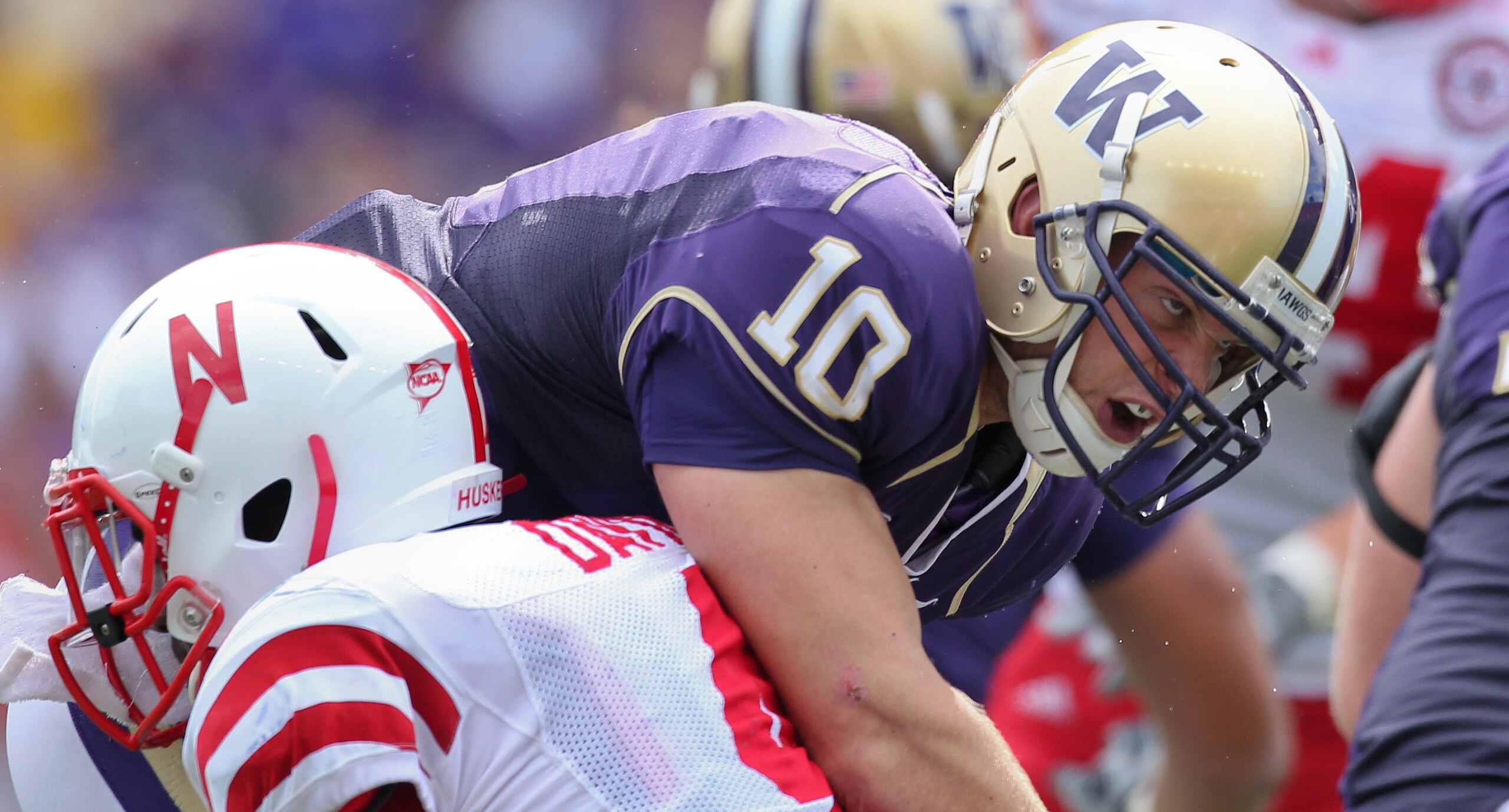 SEATTLE - SEPTEMBER 18: Quarterback Jake Locker #10 of the Washington Huskies is tackled by linebacker Lavonte David #4 of the Nebraska Cornhuskers on September 18, 2010 at Husky Stadium in Seattle, Washington. (Photo by Otto Greule Jr/Getty Images)