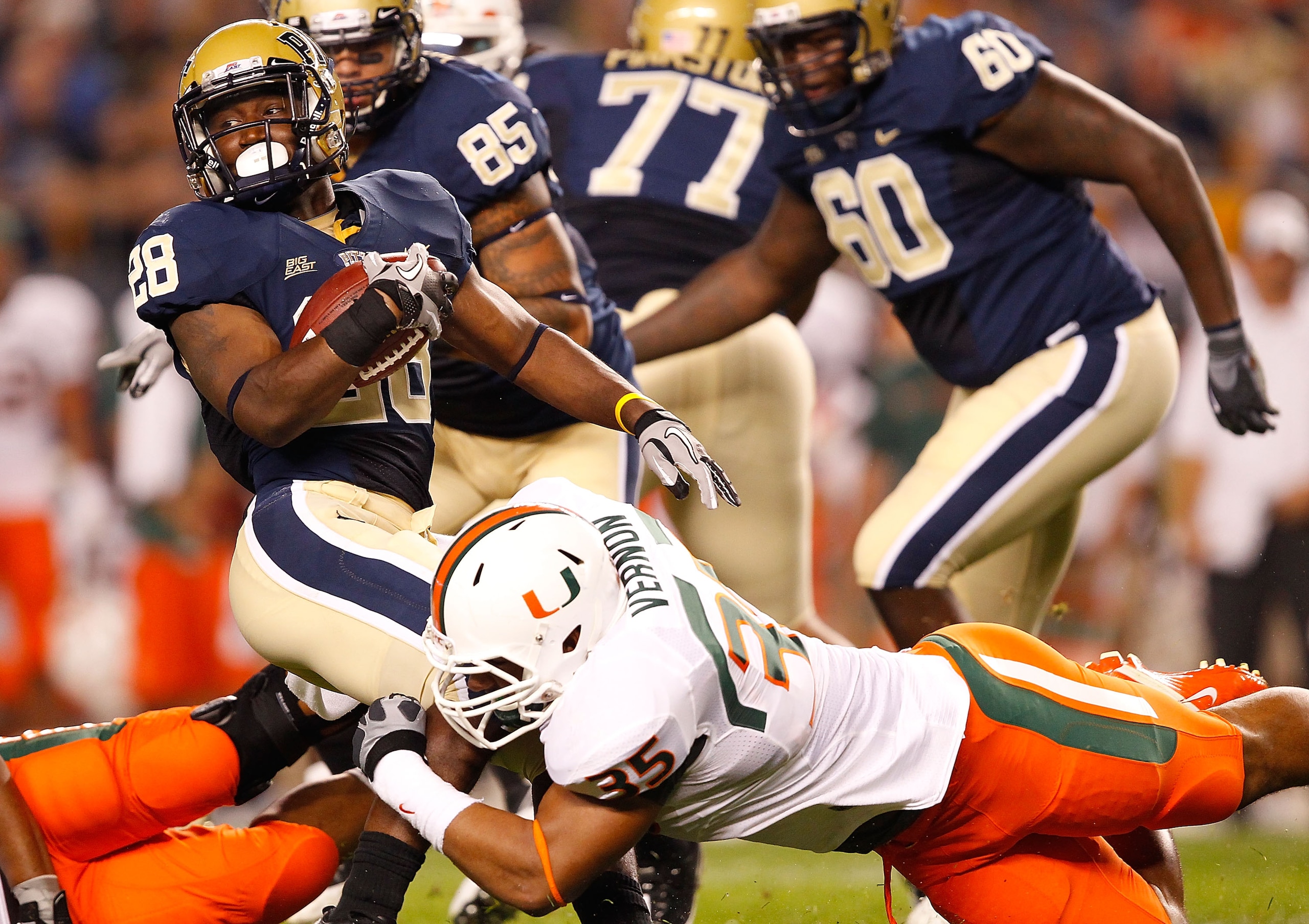 PITTSBURGH - SEPTEMBER 23:  Dion Lewis #28 of the Pittsburgh Panthers is tackled by Olivier Vernon #35 of the Miami Hurricanes on September 23, 2010 at Heinz Field in Pittsburgh, Pennsylvania.  (Photo by Jared Wickerham/Getty Images)