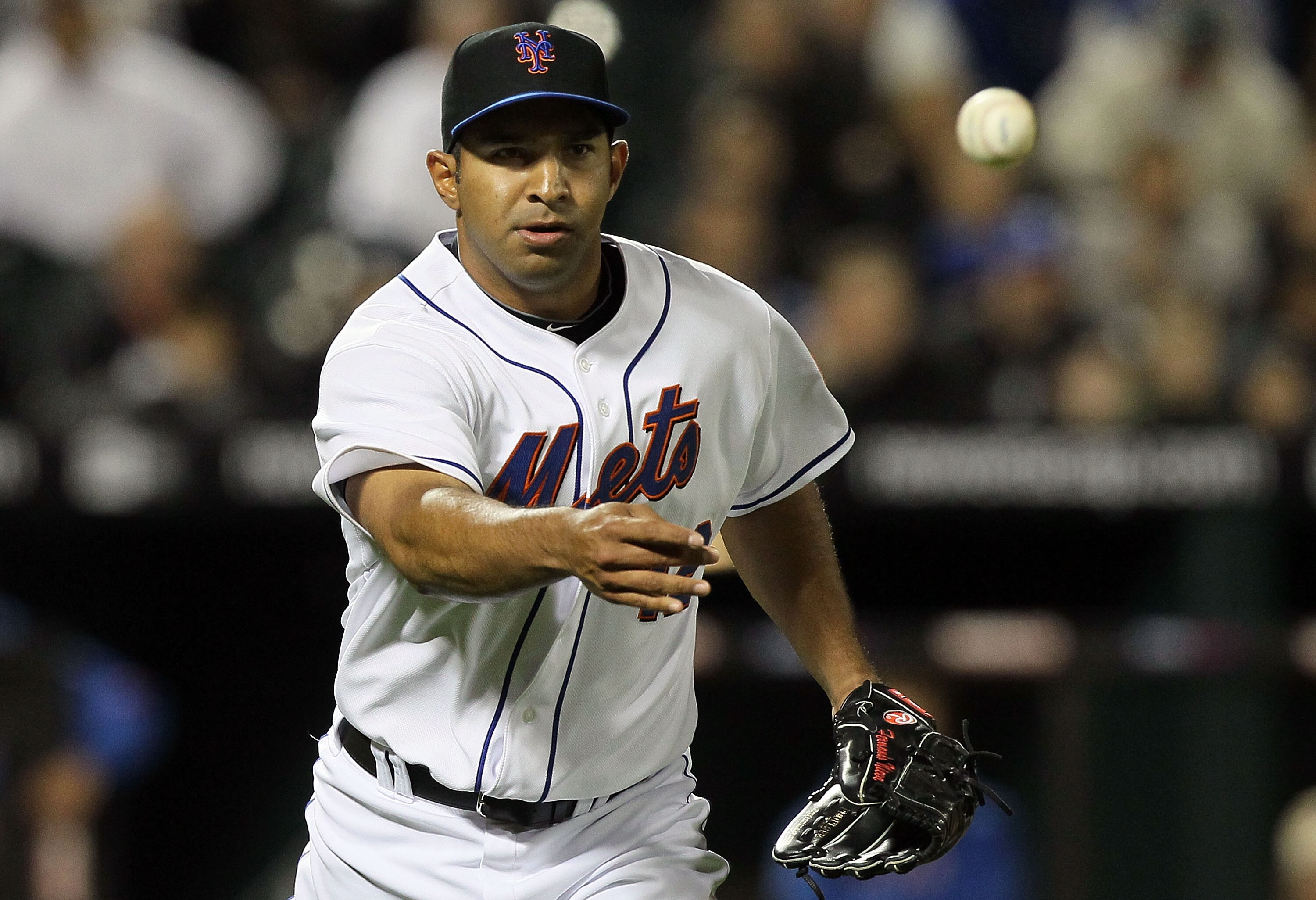 NEW YORK - APRIL 19:  Fernando Nieve #38 of the New York Mets tosses the ball to first base for an out against the Chicago Cubs on April 19, 2010 at Citi Field in the Flushing neighborhood of the Queens borough of New York City. Players from both teams ar