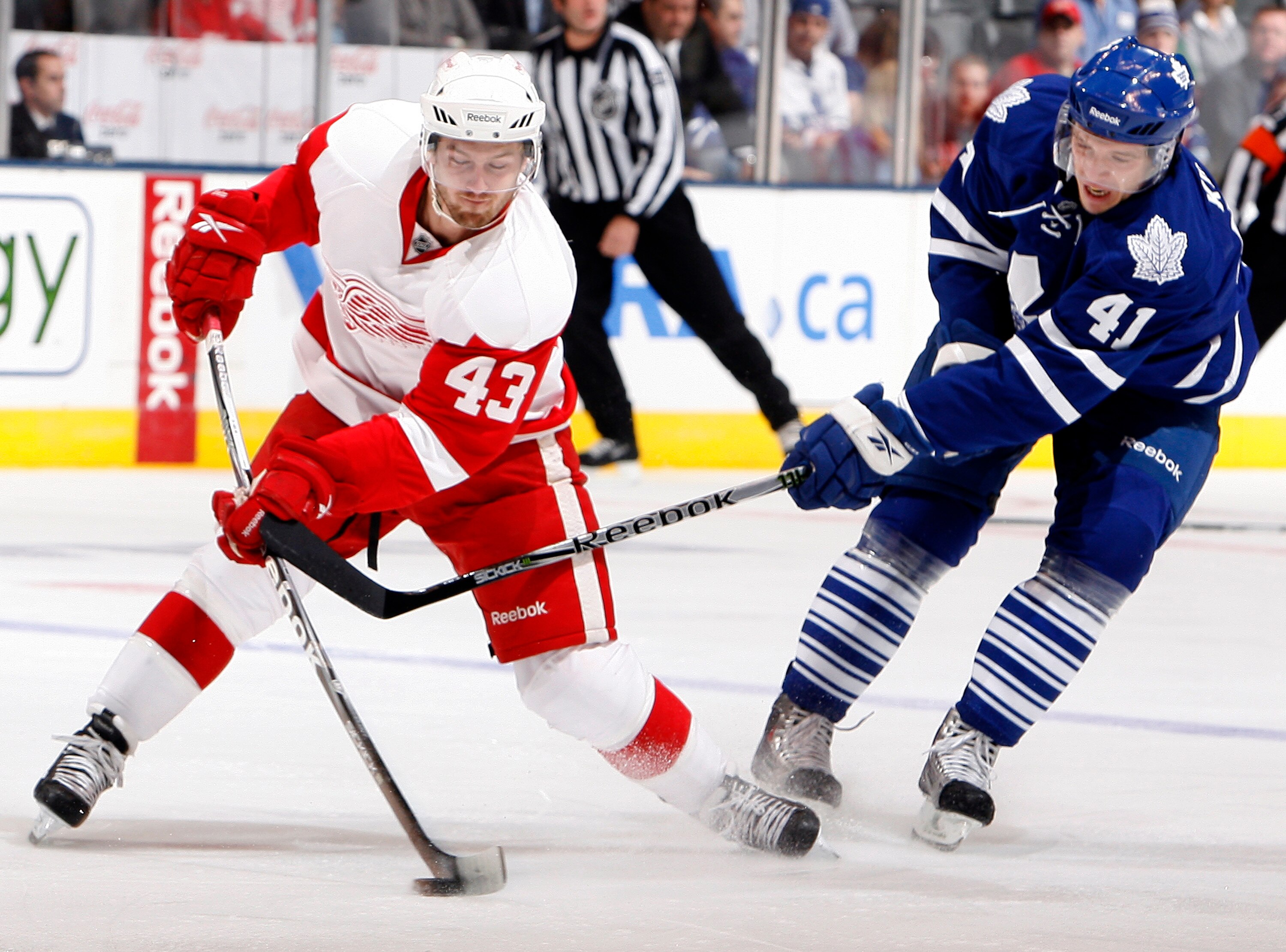 TORONTO - OCTOBER 2: Nikolai Kulemin #41 of the Toronto Maple Leafs slashes Darren Helm #43 of the Detroit Red Wings during a preseason NHL game at the Air Canada Centre October 2, 2010 in Toronto, Ontario, Canada. (Photo by Abelimages/Getty Images)