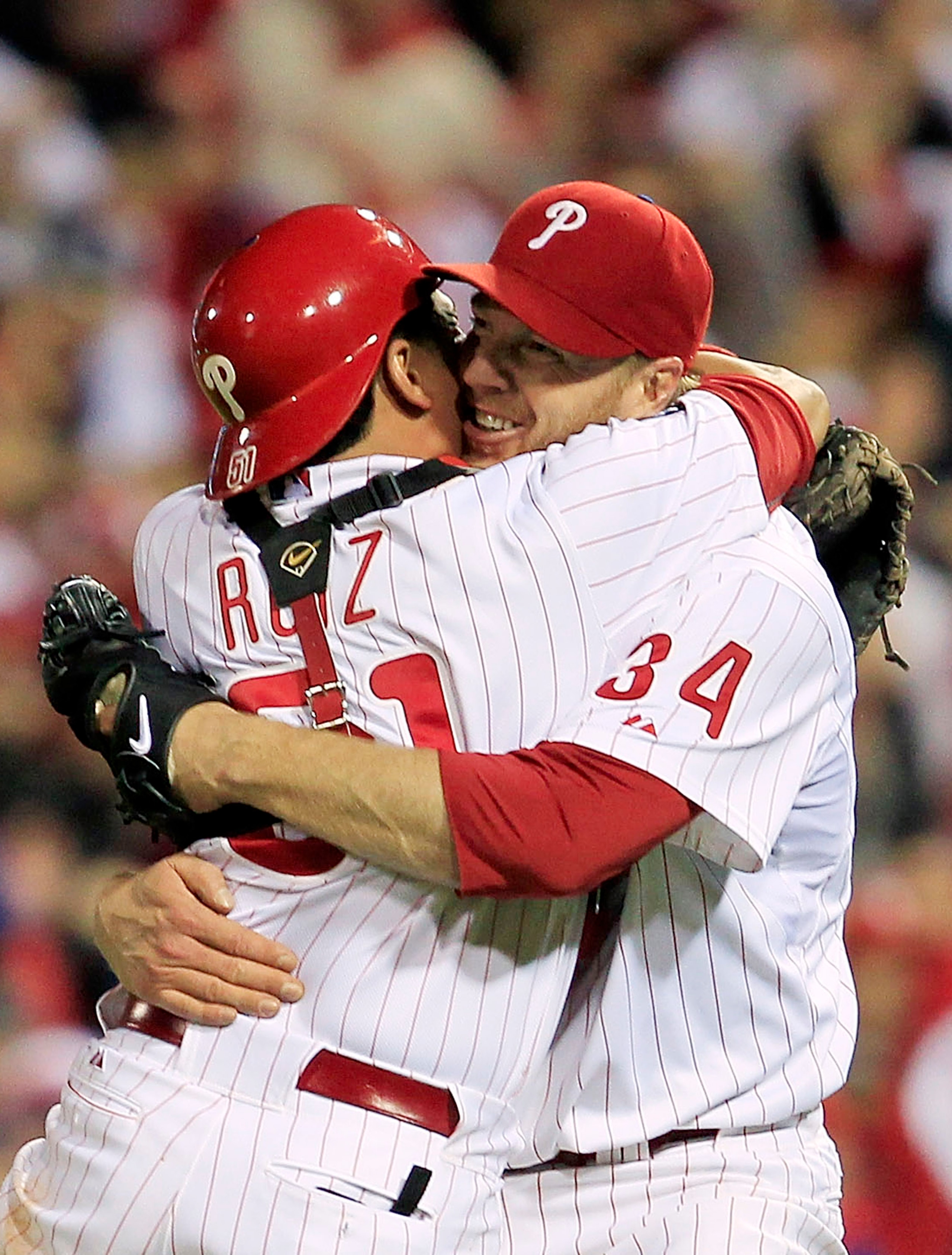 PHILADELPHIA - OCTOBER 06: (EDITORS NOTE: Alternate Crop) Roy Halladay #34 and Carlos Ruiz #51 of the Philadelphia Phillies celebrate Halladay's no-hitter and the win in Game 1 of the NLDS against the Cincinnati Reds at Citizens Bank Park on October 6, 20