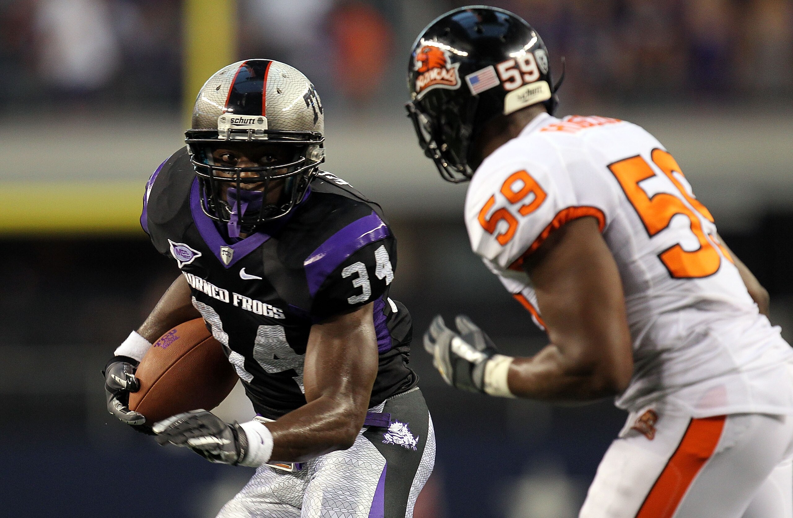 ARLINGTON, TX - SEPTEMBER 04:  Tailback Ed Wesley #34 of the TCU Horned Frogs runs the ball past Dwight Roberson #59 of the Oregon State Beavers at Cowboys Stadium on September 4, 2010 in Arlington, Texas.  (Photo by Ronald Martinez/Getty Images)