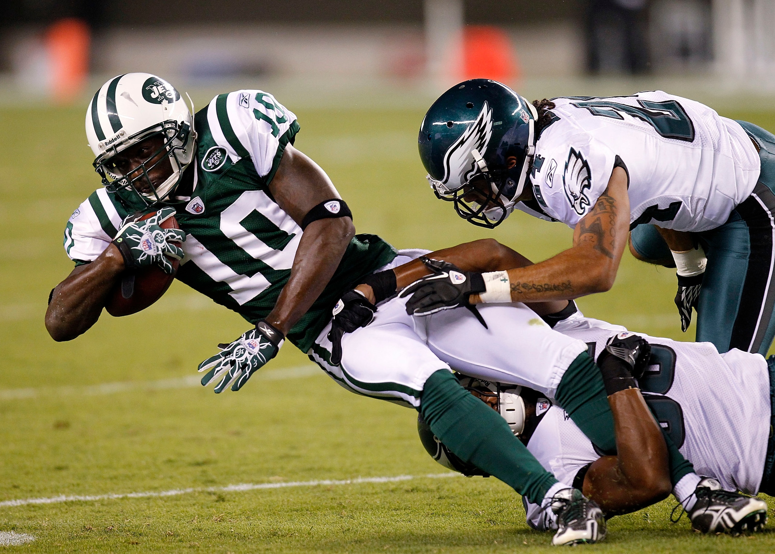 PHILADELPHIA - SEPTEMBER 02: Trevard Lindley #35 and Macho Harris #24 of the Philadelphia Eagles take down Santonio Holmes #10 of the New York Jets in a preseason game at Lincoln Financial Field on September 2, 2010 in Philadelphia, Pennsylvania. (Photo PHILADELPHIA - SEPTEMBER 02: Trevard Lindley #35 and Macho Harris #24 of the Philadelphia Eagles take down Santonio Holmes #10 of the New York Jets in a preseason game at Lincoln Financial Field on September 2, 2010 in Philadelphia, Pennsylvania. (Photo