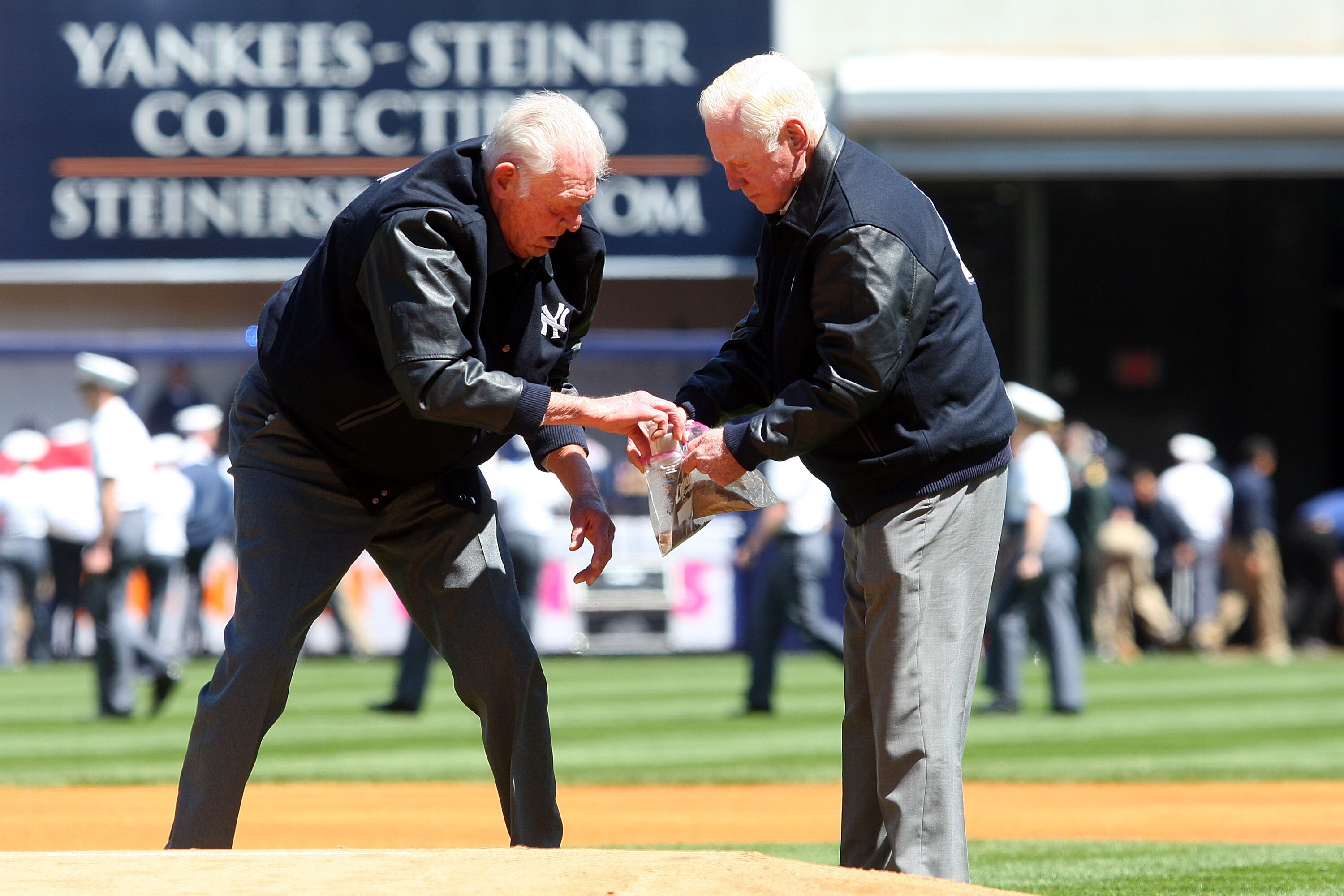 NEW YORK - APRIL 16:  Former New York Yankees Don Larsen and Whitey Ford take dirt from the pitchers mound during an opening day ceremony at the new Yankee Stadium on April 16, 2009 in the Bronx borough of New York City. This is the first regular season M