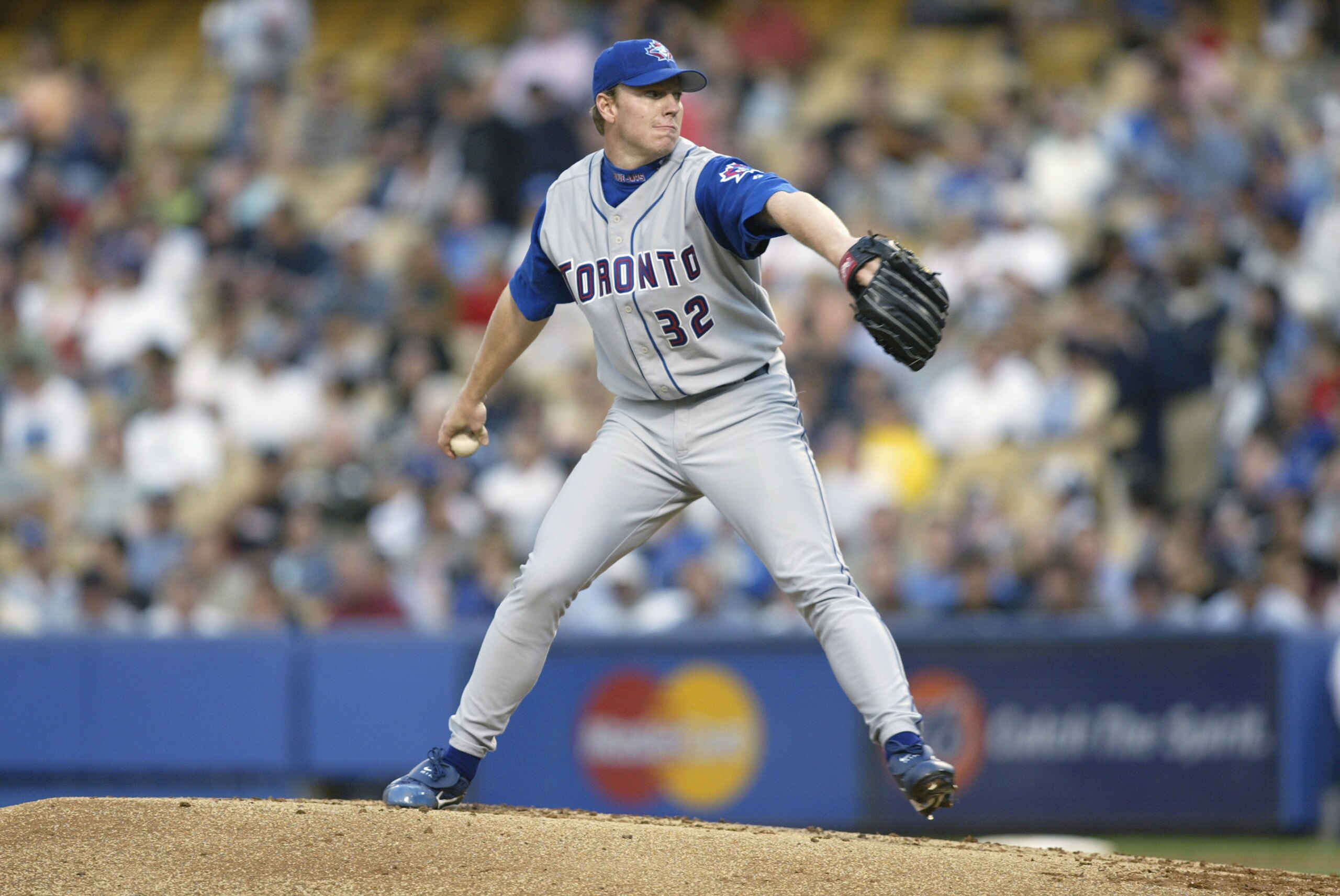LOS ANGELES, CA - JUNE 18:  Pitcher Roy Halladay #32  the Toronto Blue Jays winds back to pitch the ball during their game against  the Los Angeles Dodgers on June 18, 2002 at Dodger Stadium in Los Angeles, California. The Blue Jays won 2-1.  (Photo by Je