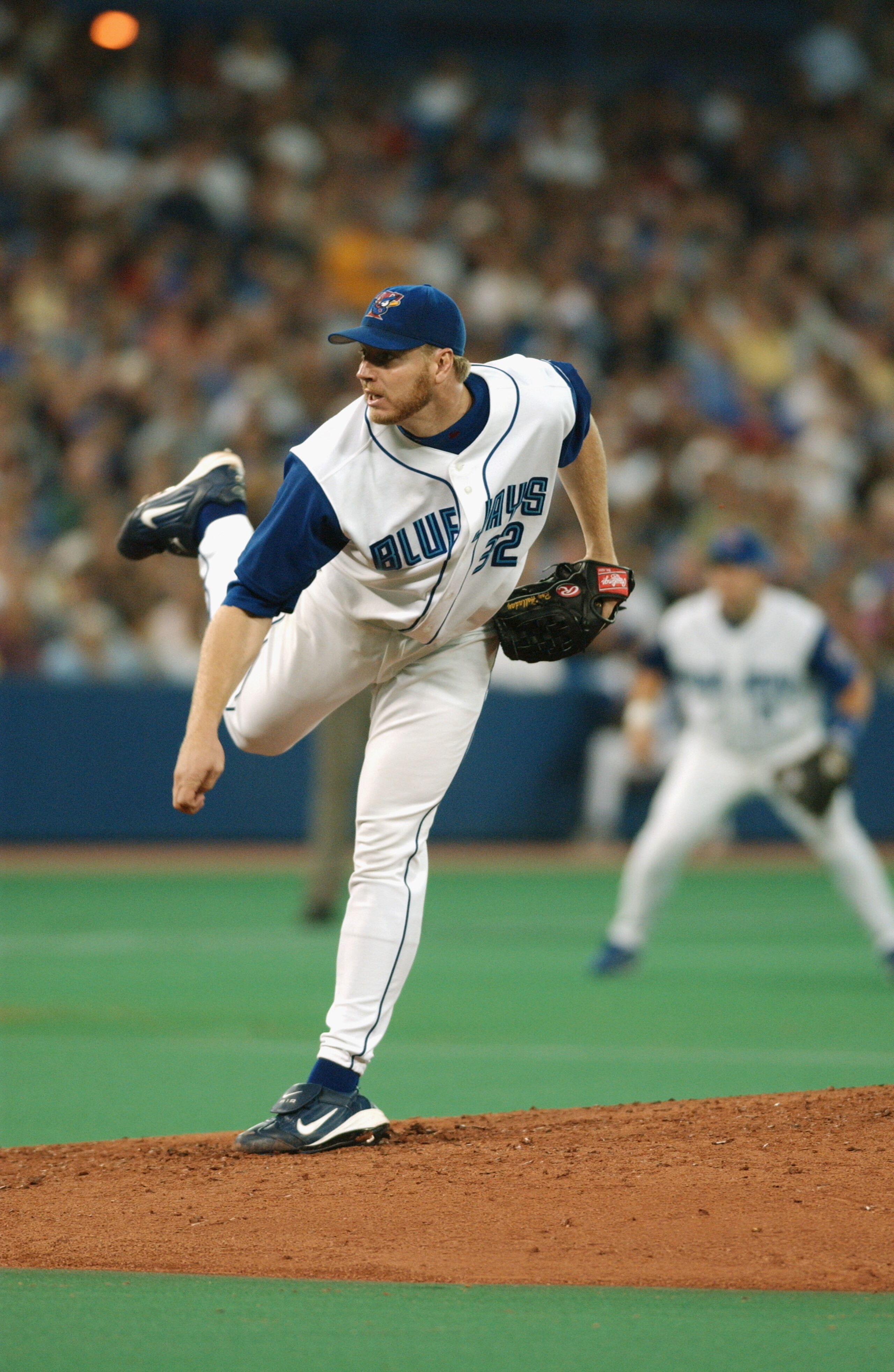 TORONTO - JULY 12:  Pitcher Roy Halladay #32 of the Toronto Blue Jays delivers a pitch during the American League game against the New York Yankees at SkyDome on July 12, 2003 in Toronto, Ontario. The Blue Jays won the game 10-3.  (Photo By Dave Sandford/