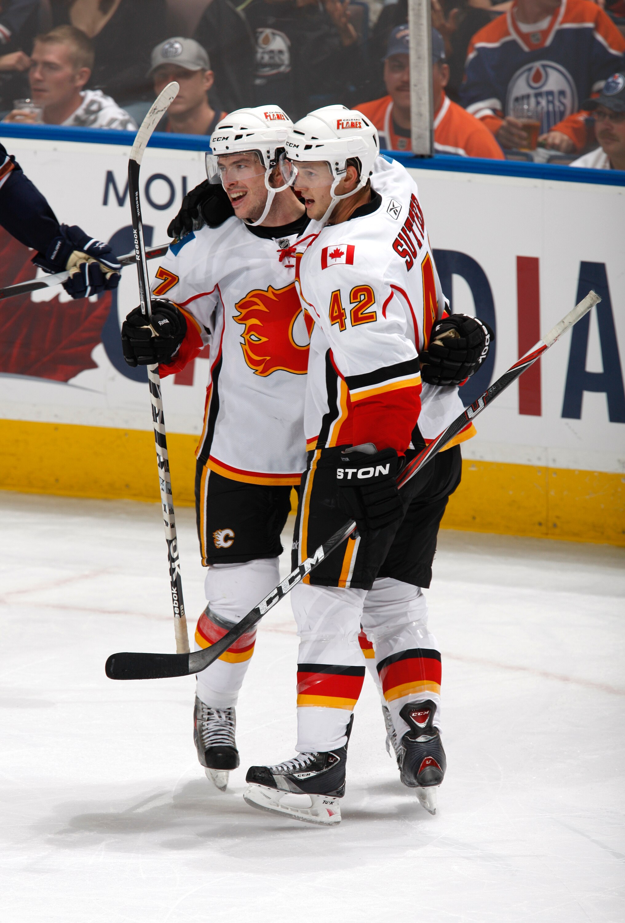 EDMONTON, CANADA - OCTOBER 1:  Jon Rheault #47 and Brett Sutter #42 of the Calgary Flames celebrate Rheault's goal in the third period at Rexall Place October 1, 2010 in Edmonton, Alberta, Canada. (Photo by Dale MacMillan/Getty Images)