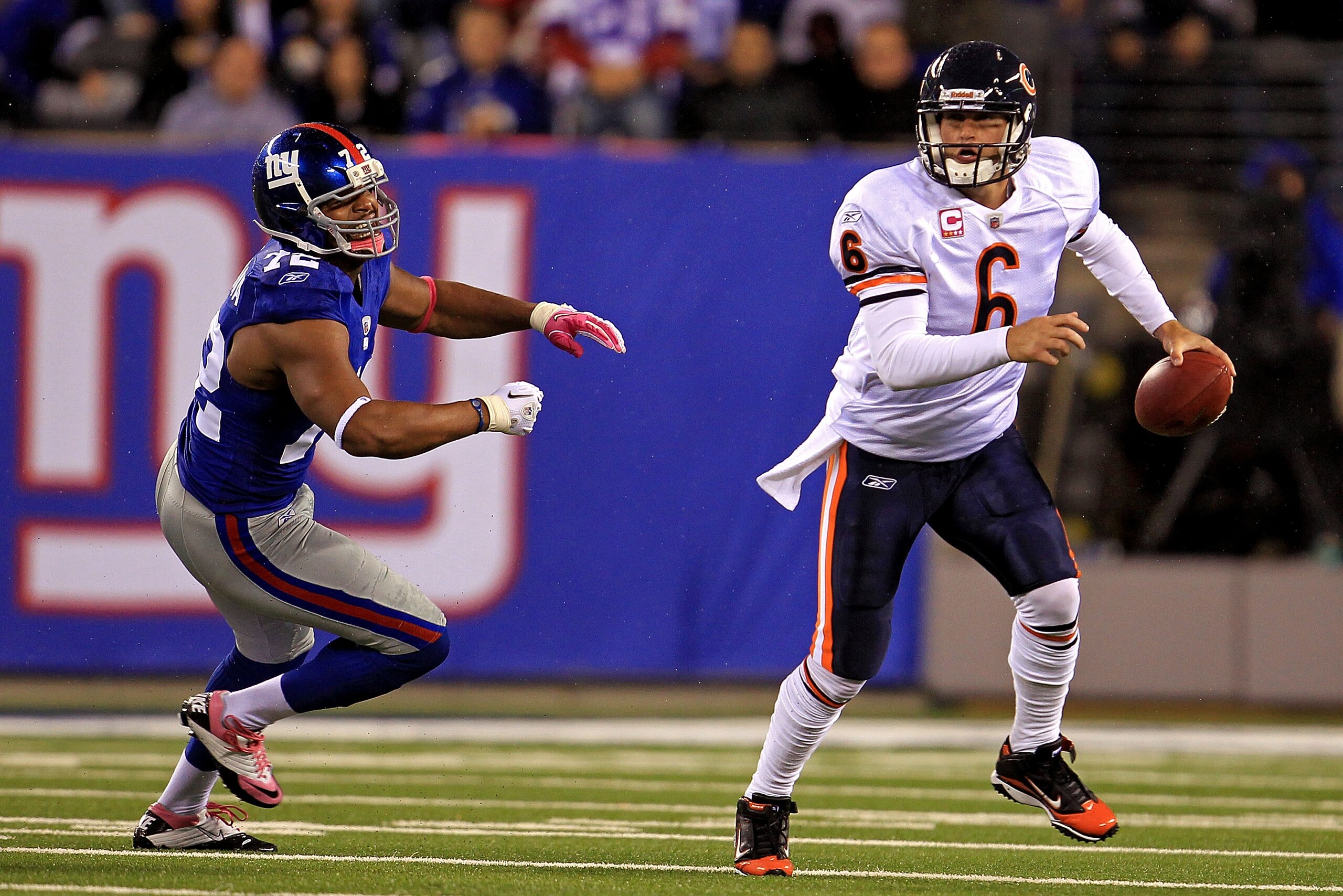 EAST RUTHERFORD, NJ - OCTOBER 03:  Jay Cutler #6 of the Chicago Bears gets chased by Osi Umenyiora #72 of the New York Giants at New Meadowlands Stadium on October 3, 2010 in East Rutherford, New Jersey.  (Photo by Chris McGrath/Getty Images)