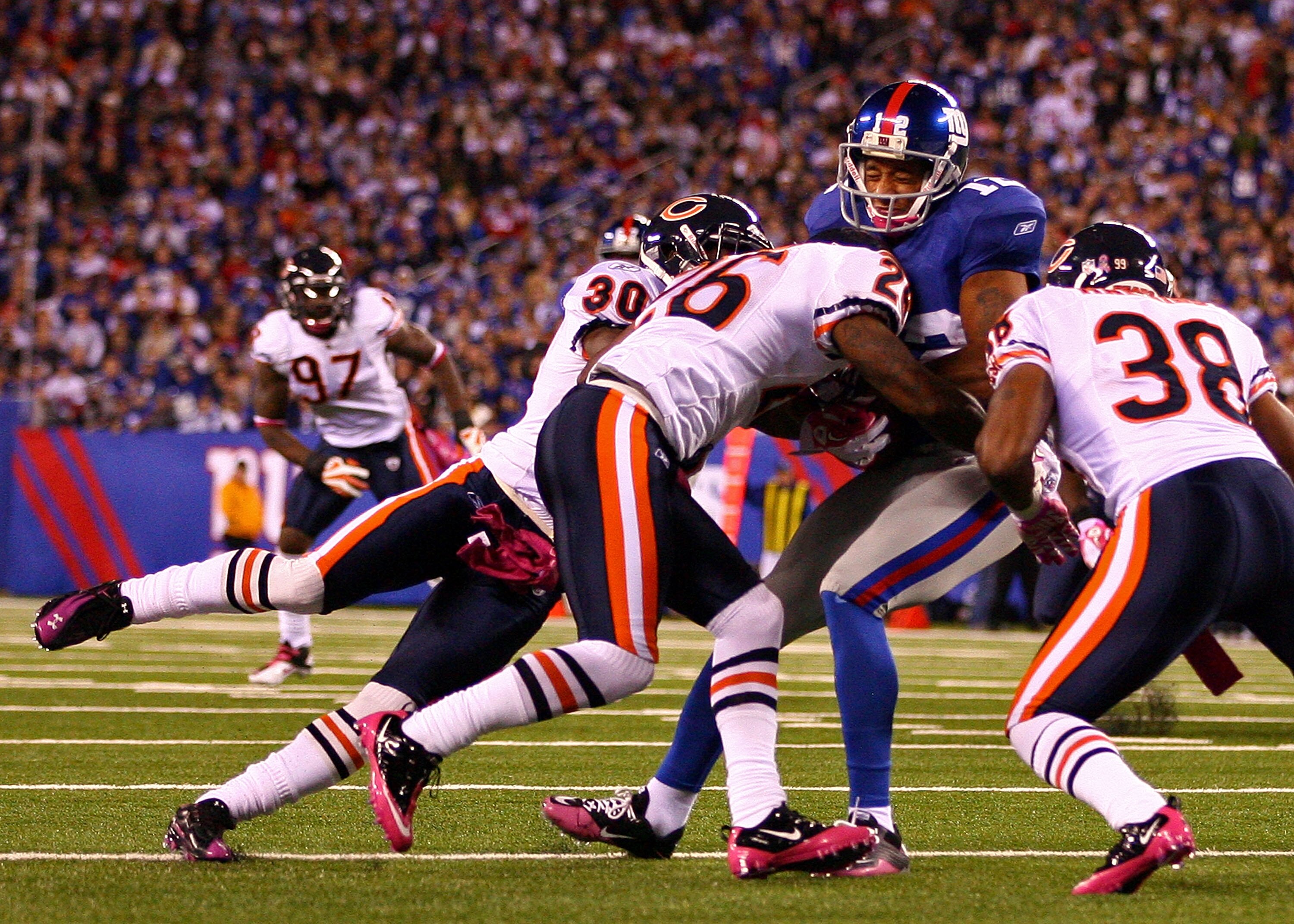 EAST RUTHERFORD, NJ - OCTOBER 03:  Tim Jennings #26, D.J. Moore #30 and Danieal Manning #38 of the Chicago Bears converge on Steve Smith #12 of the New York Giants at New Meadowlands Stadium on October 3, 2010 in East Rutherford, New Jersey.  (Photo by An