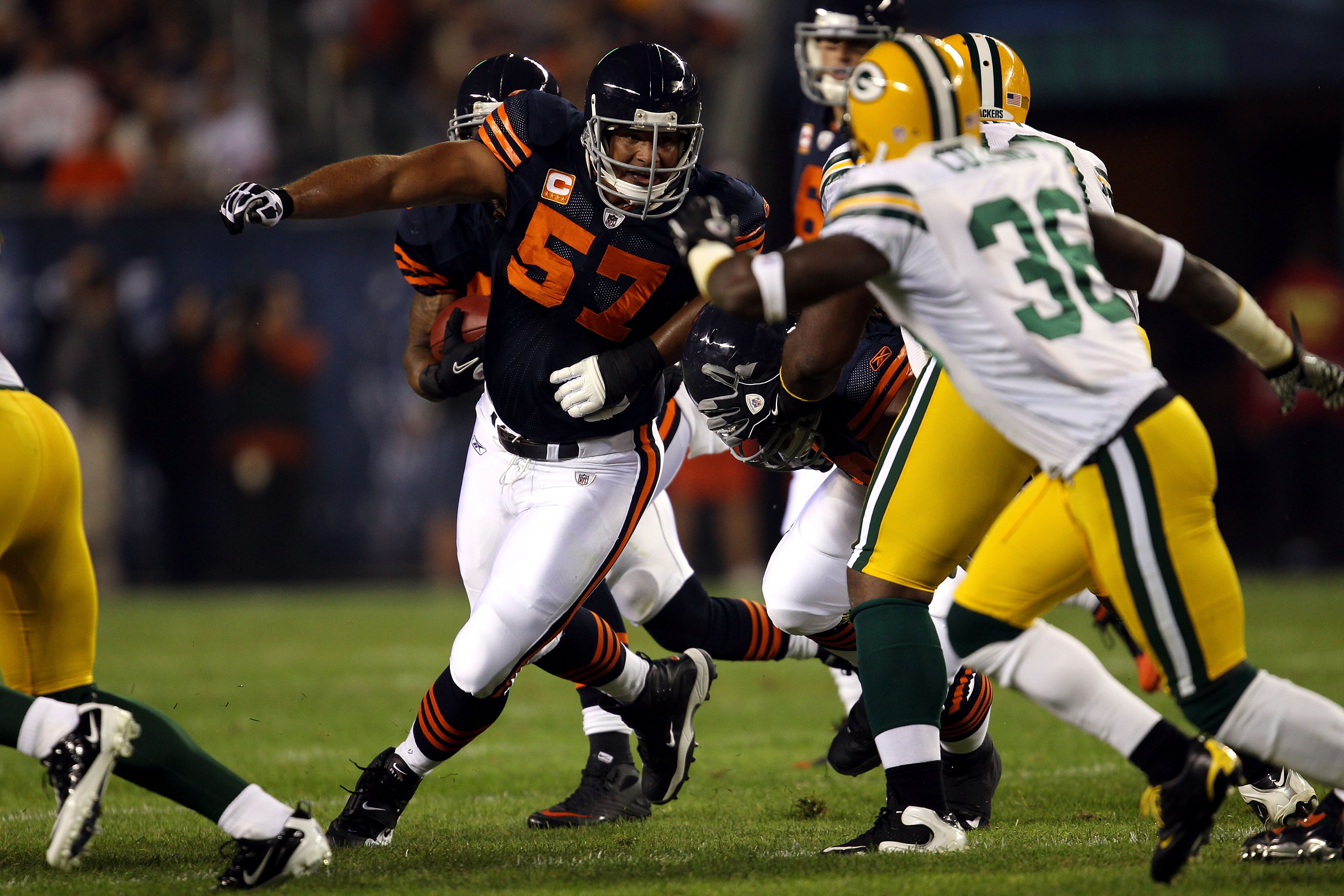 CHICAGO - SEPTEMBER 27:  Center Olin Kreutz #57 of the Chicago Bears pulls down the line to run block against the Green Bay Packers at Soldier Field on September 27, 2010 in Chicago, Illinois. The Bears won 20-17.  (Photo by Jonathan Daniel/Getty Images)