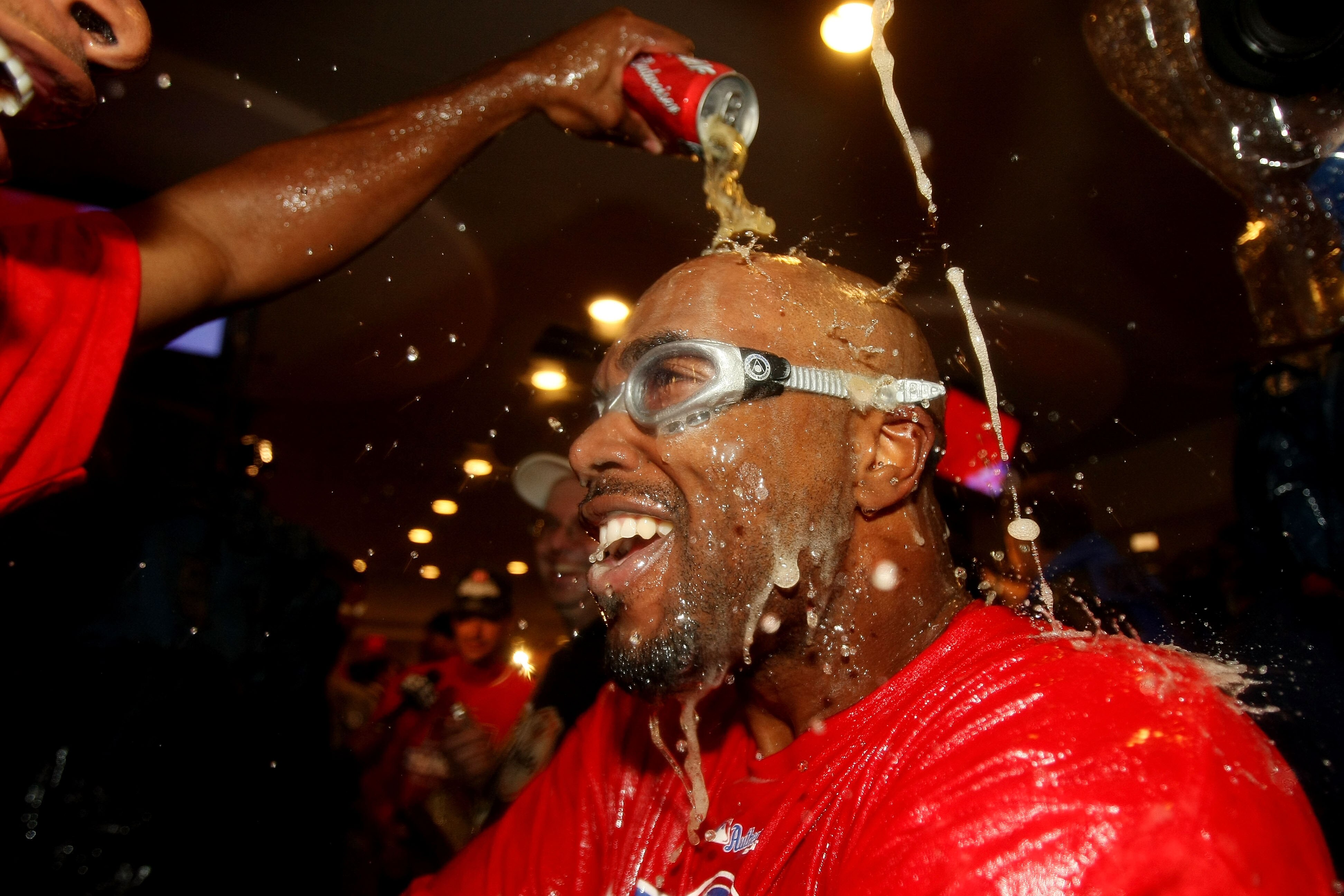 PHILADELPHIA - OCTOBER 21:  Jimmy Rollins #11 of the Philadelphia Phillies is sprayed down with champagne as they celebrate defeating the Los Angeles Dodgers 10-4 to advance to the World Series in Game Five of the NLCS during the 2009 MLB Playoffs at Citi