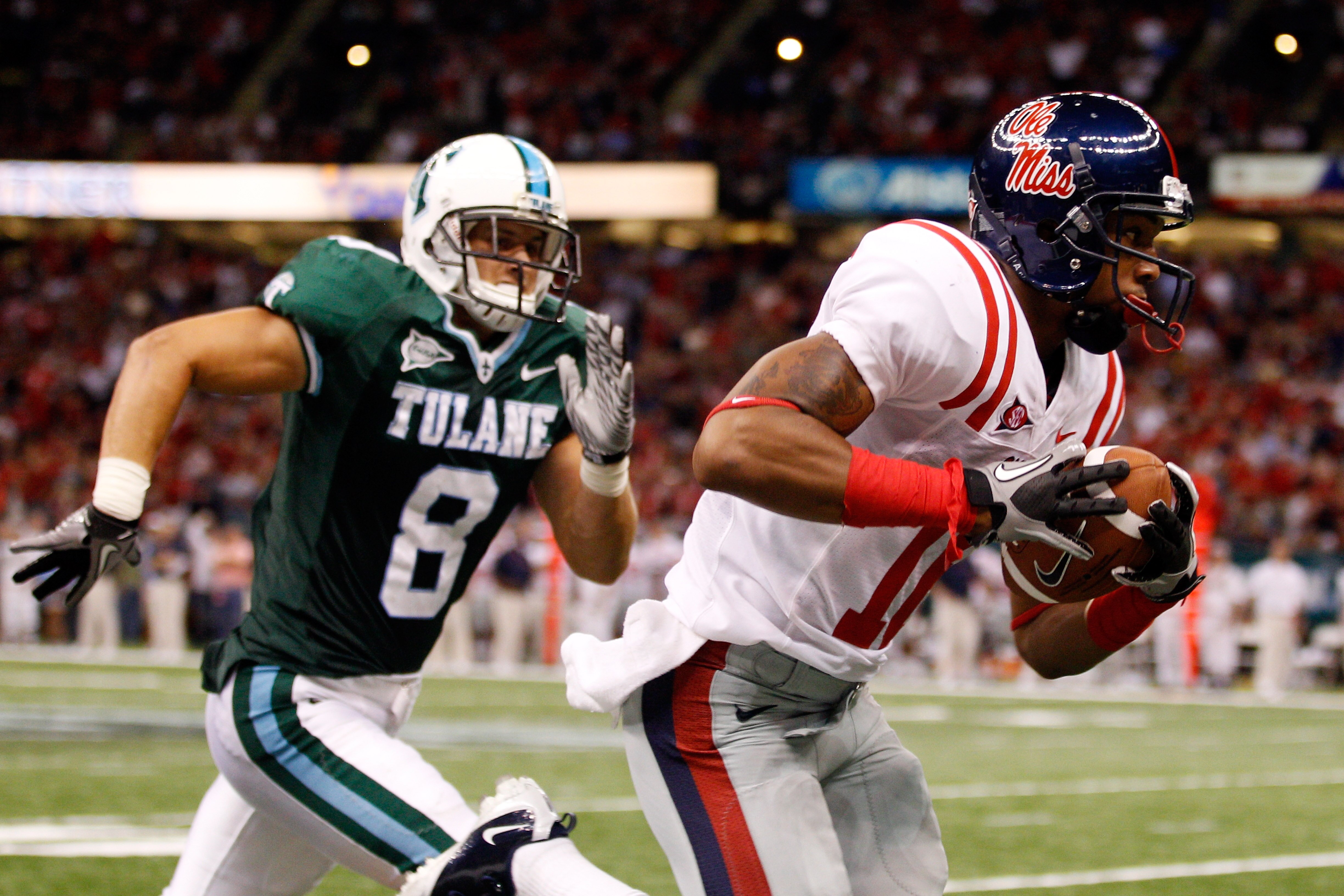 NEW ORLEANS - SEPTEMBER 11:  Markeith Summers #16 of the Ole Miss Rebels catches a pass over Alex Wacha #8 of the the Tulane Green Wave at the Louisiana Superdome on September 11, 2010 in New Orleans, Louisiana.  Ole Miss defeated Tulane 27-13.  (Photo by