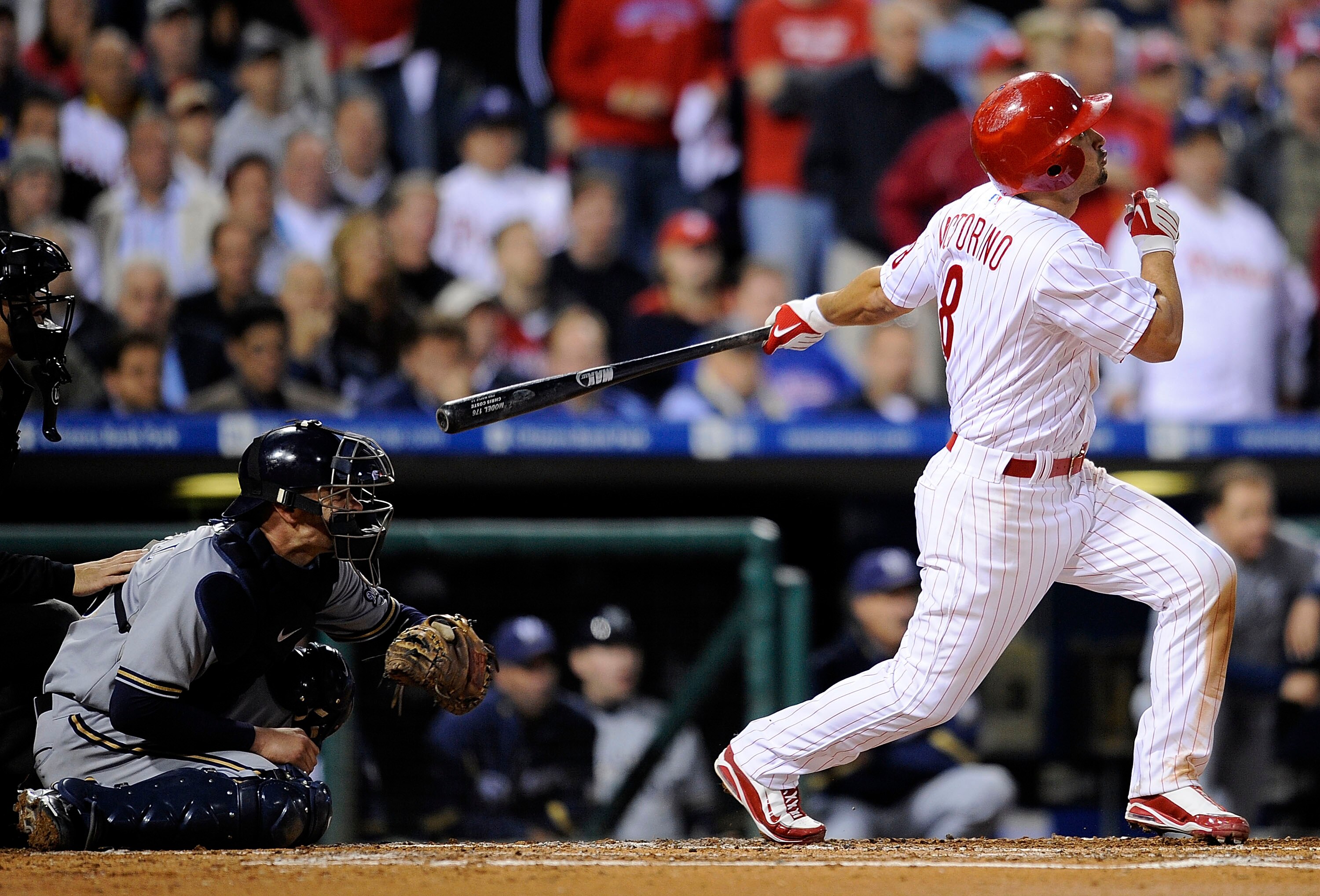 PHILADELPHIA - OCTOBER 02:  Shane Victorino #8 of the Philadelphia Phillies hits a grand slam in front of Jason Kendall #18 of the Milwaukee Brewers in the second inning of Game 2 of the NLDS Playoff at Citizens Bank Ballpark on October 2, 2008 in Philade