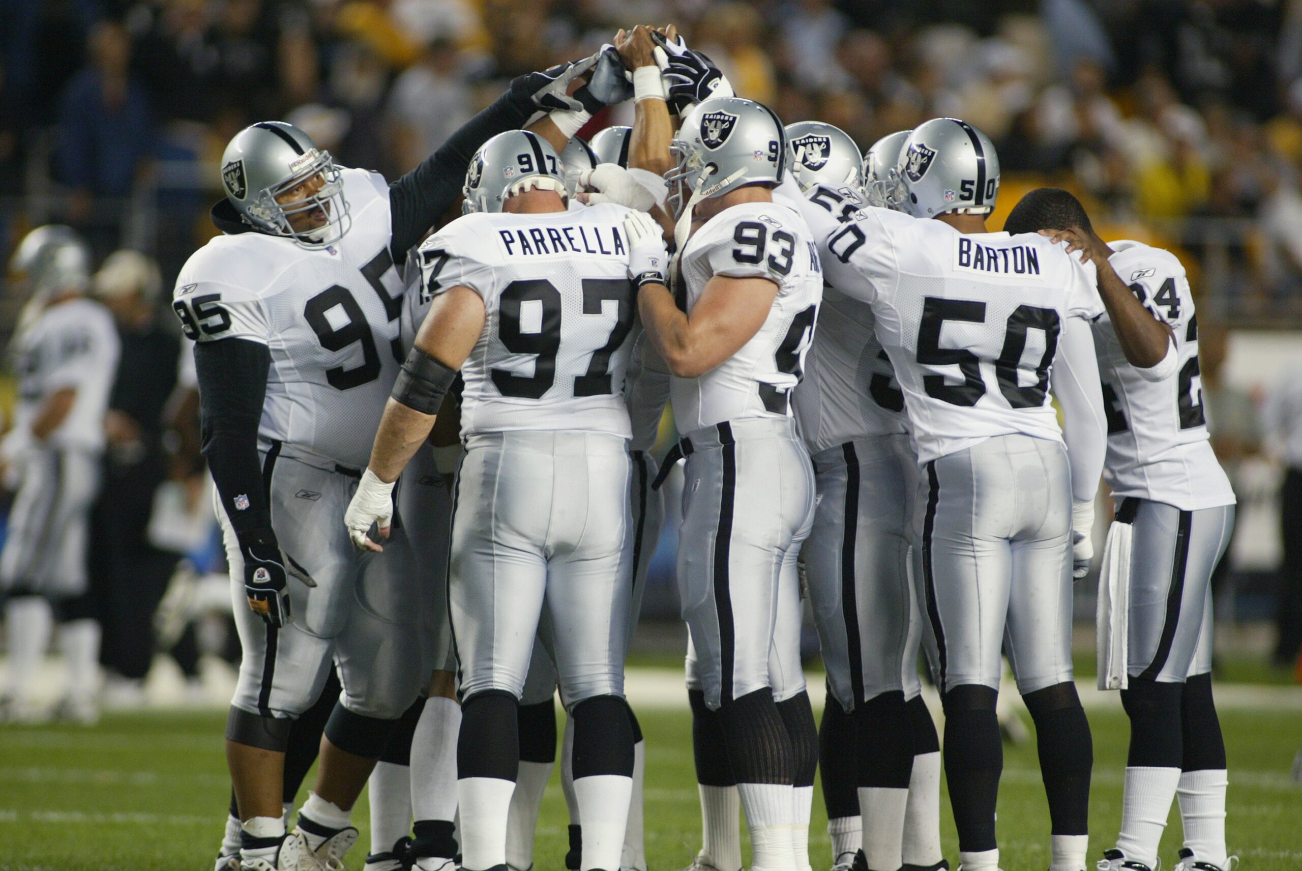 PITTSBURGH, PA - SEPTEMBER 15:  The Oakland Raiders huddle during the game against the Pittsburgh Steelers on September 15, 2002 at Heinz Field in Pittsburgh, Pennsylvania.  Oakland won 30-17.  (Photo by Rick Stewart/Getty Images)
