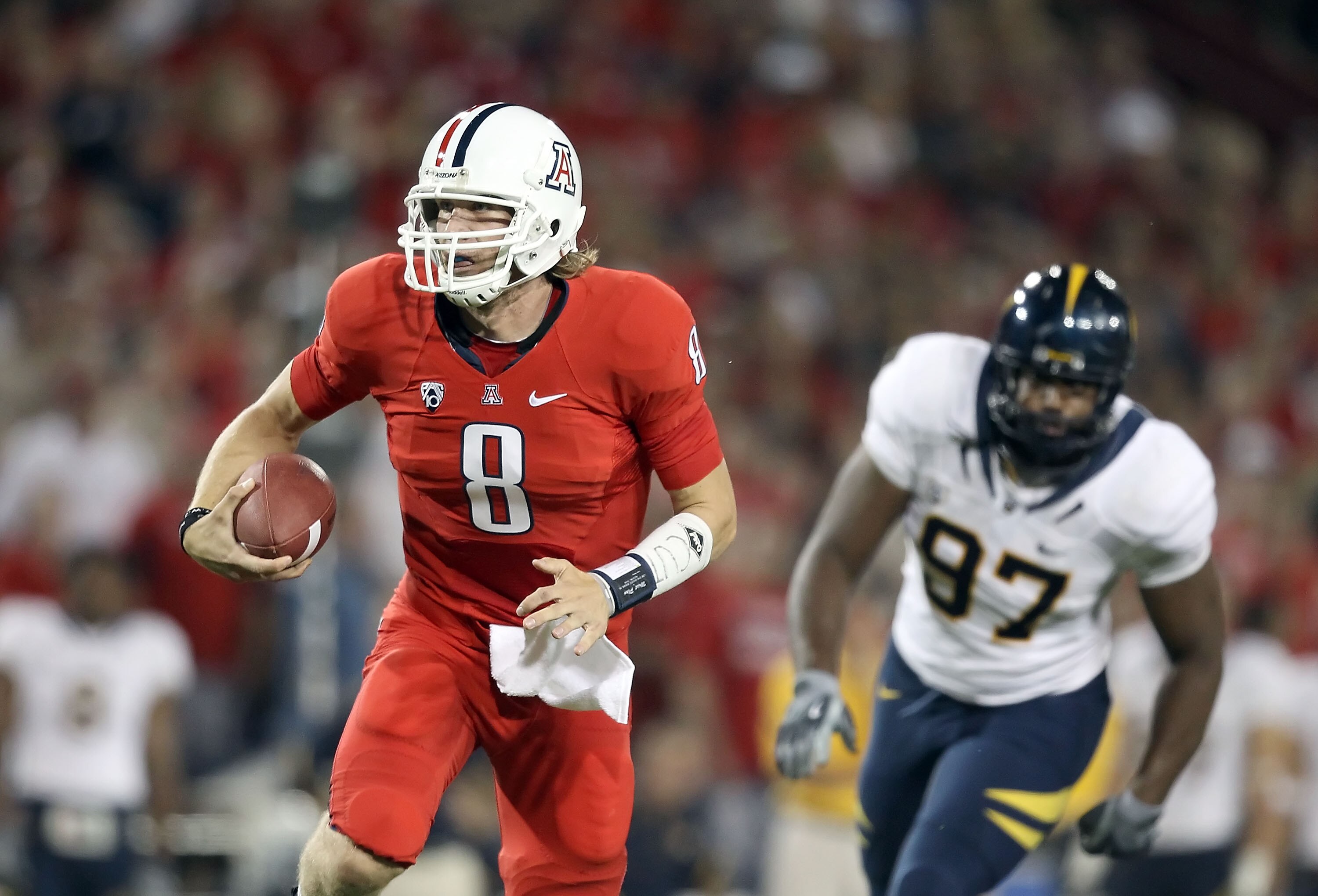 TUCSON, AZ - SEPTEMBER 25:  Quarterback Nick Foles #8 of the Arizona Wildcats scrambles with the ball during the college football game against the California Golden Bears at Arizona Stadium on September 25, 2010 in Tucson, Arizona.   The Wildcats defeated