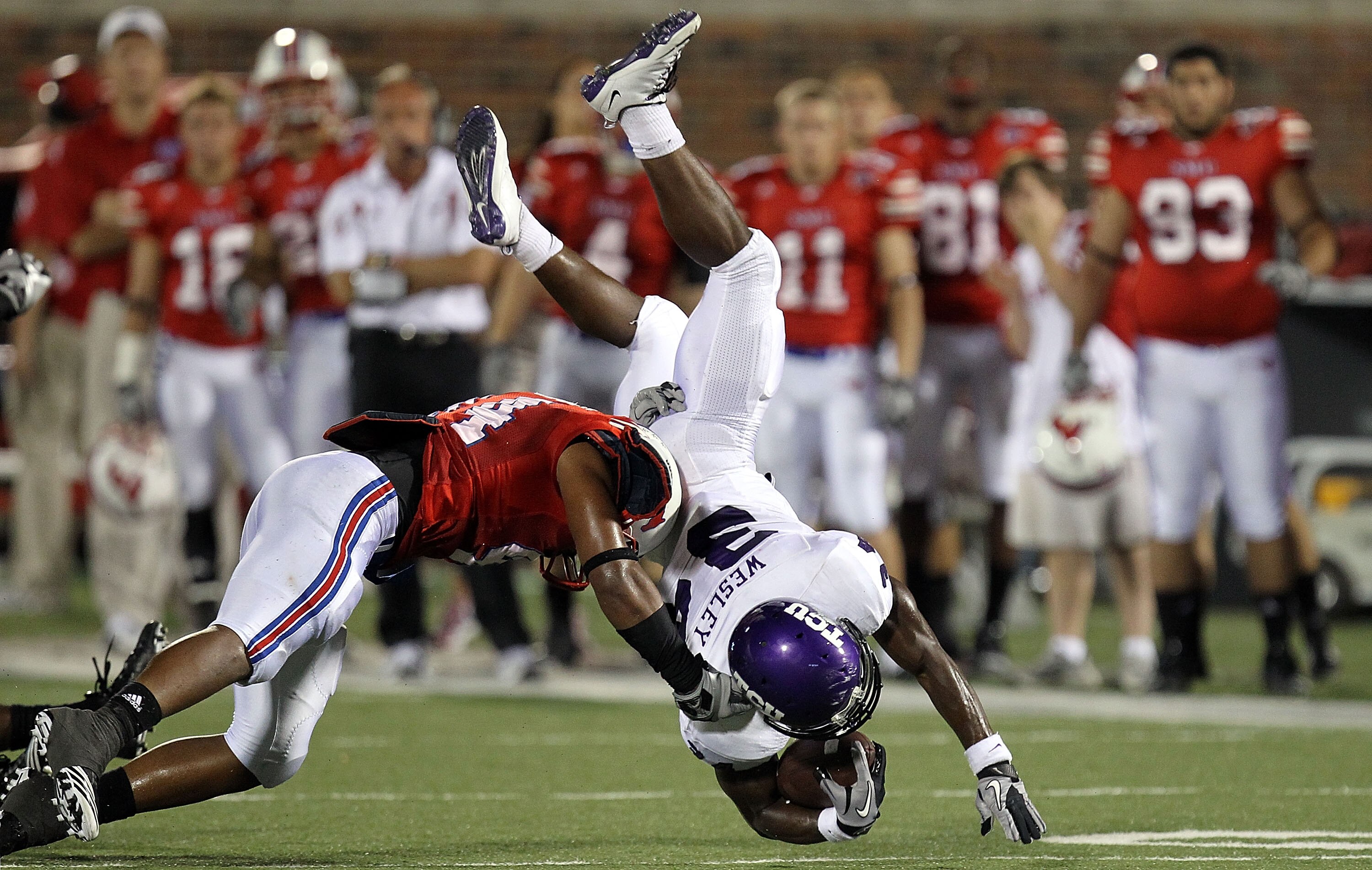 DALLAS - SEPTEMBER 24:  Tailback Ed Wesley #34 of the TCU Horned Frogs is tackled by Taylor Reed #44 of the SMU Mustangs at Gerald J. Ford Stadium on September 24, 2010 in Dallas, Texas.  (Photo by Ronald Martinez/Getty Images)