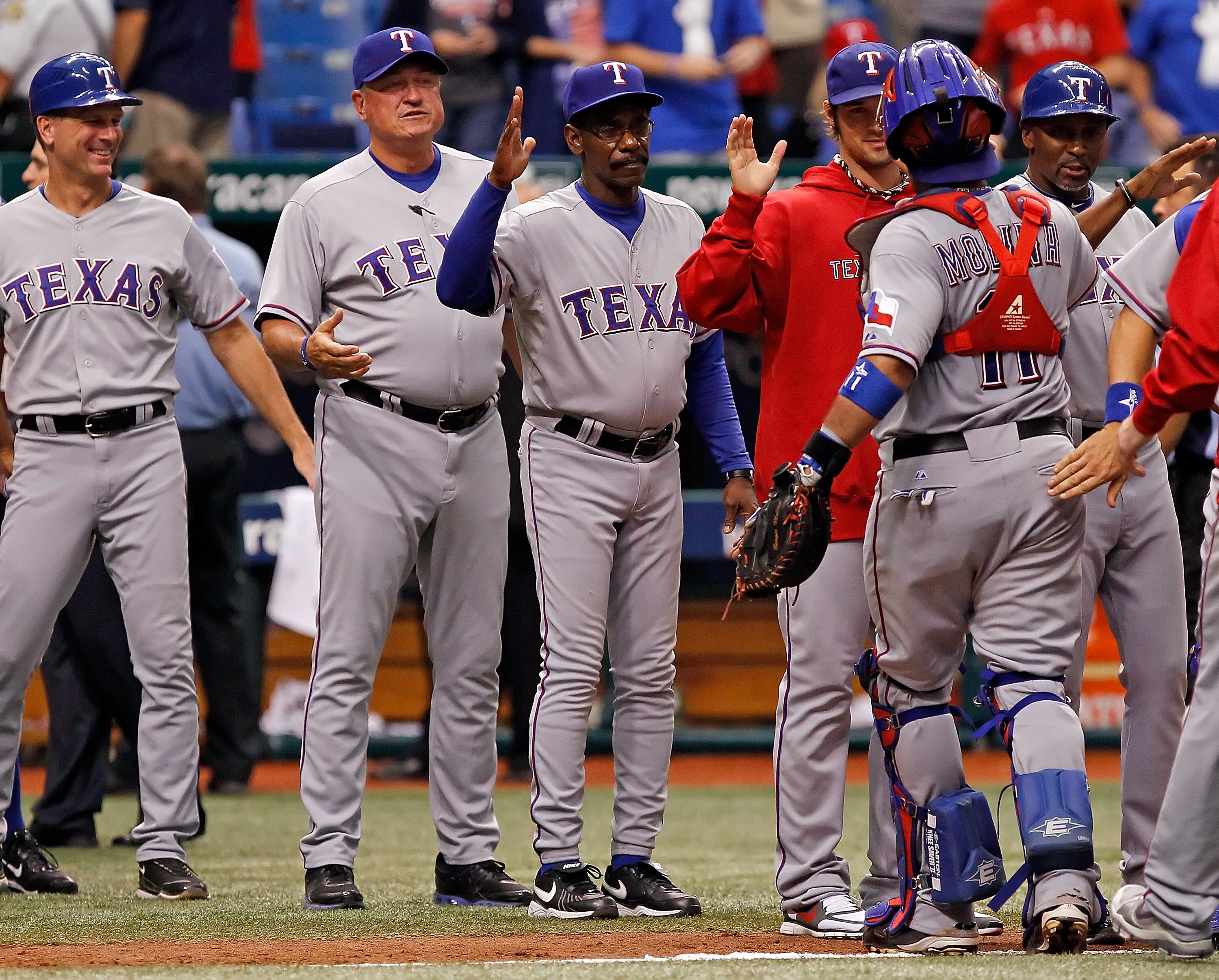 ST. PETERSBURG - OCTOBER 06:  Manager Ron Washington of the Texas Rangers congratulates catcher Bengie Molina #11 after winning the game against the Tampa Bay Rays during Game 1 of the ALDS at Tropicana Field on October 6, 2010 in St. Petersburg, Florida.