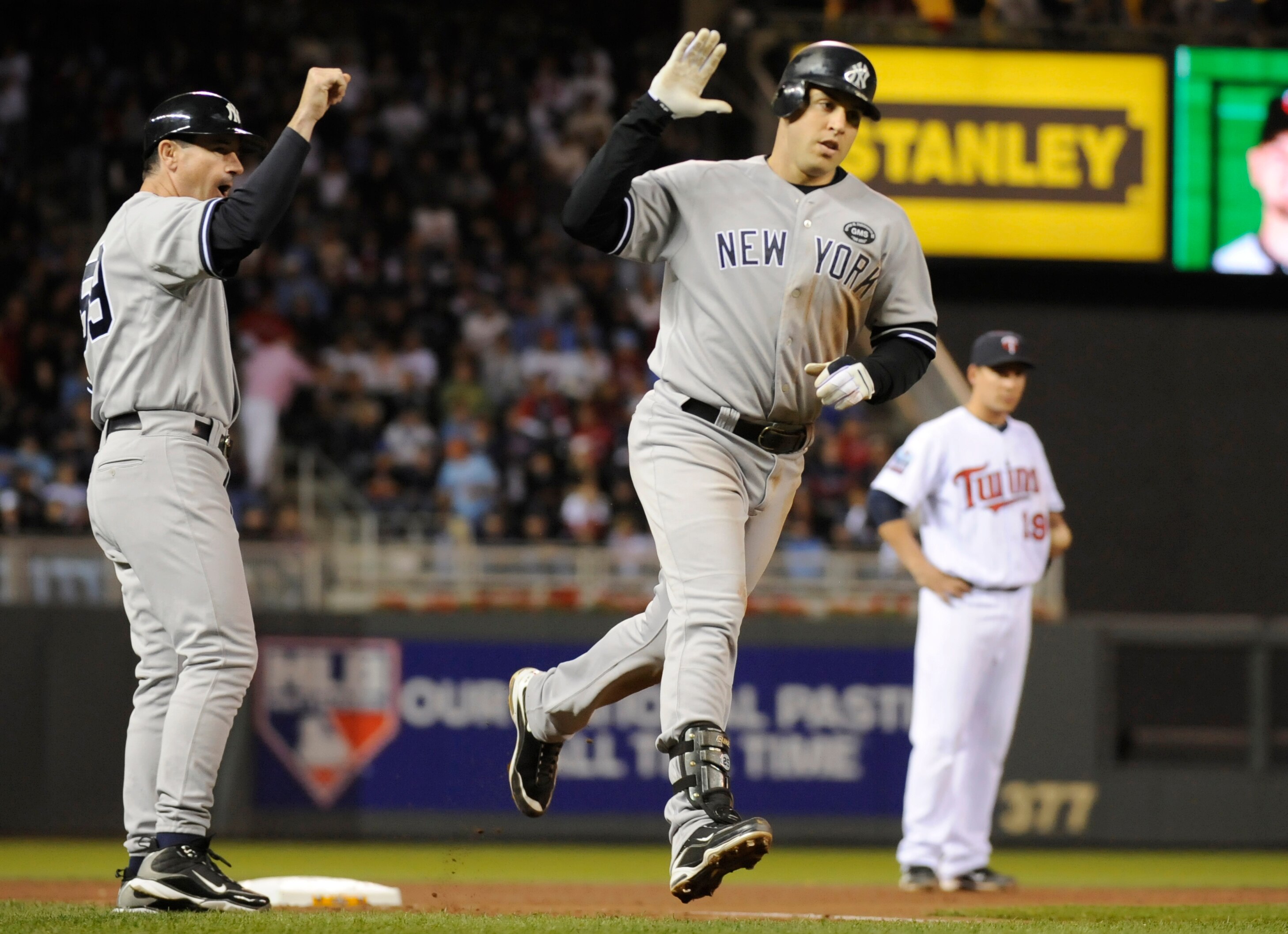 MINNEAPOLIS, MN - OCTOBER 6: Mark Teixeira #25 of the New York Yankees celebrates a two-run home run with third base coach Rob Thomson #59 during game one of the ALDS against the Minnesota Twins on October 6, 2010 at Target Field in Minneapolis, Minnesota