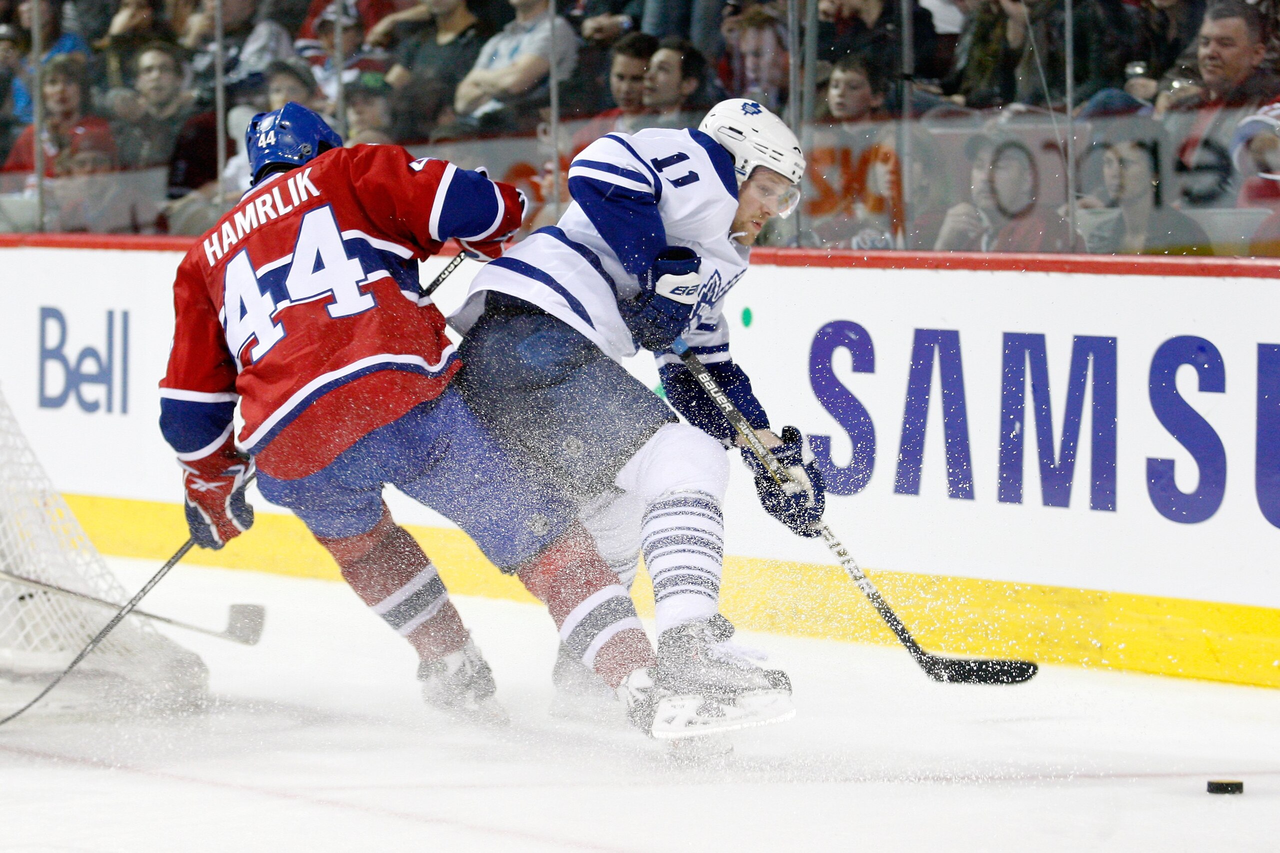 MONTREAL- APRIL 10:  Fredrik Sjostrom #11 of the Toronto Maple Leafs and Roman Hamrlik #44 of the Montreal Canadiens battle for the puck during the NHL game on April 10, 2010 at the Bell Centre in Montreal, Quebec, Canada.  The Maple Leafs defeated the Ca