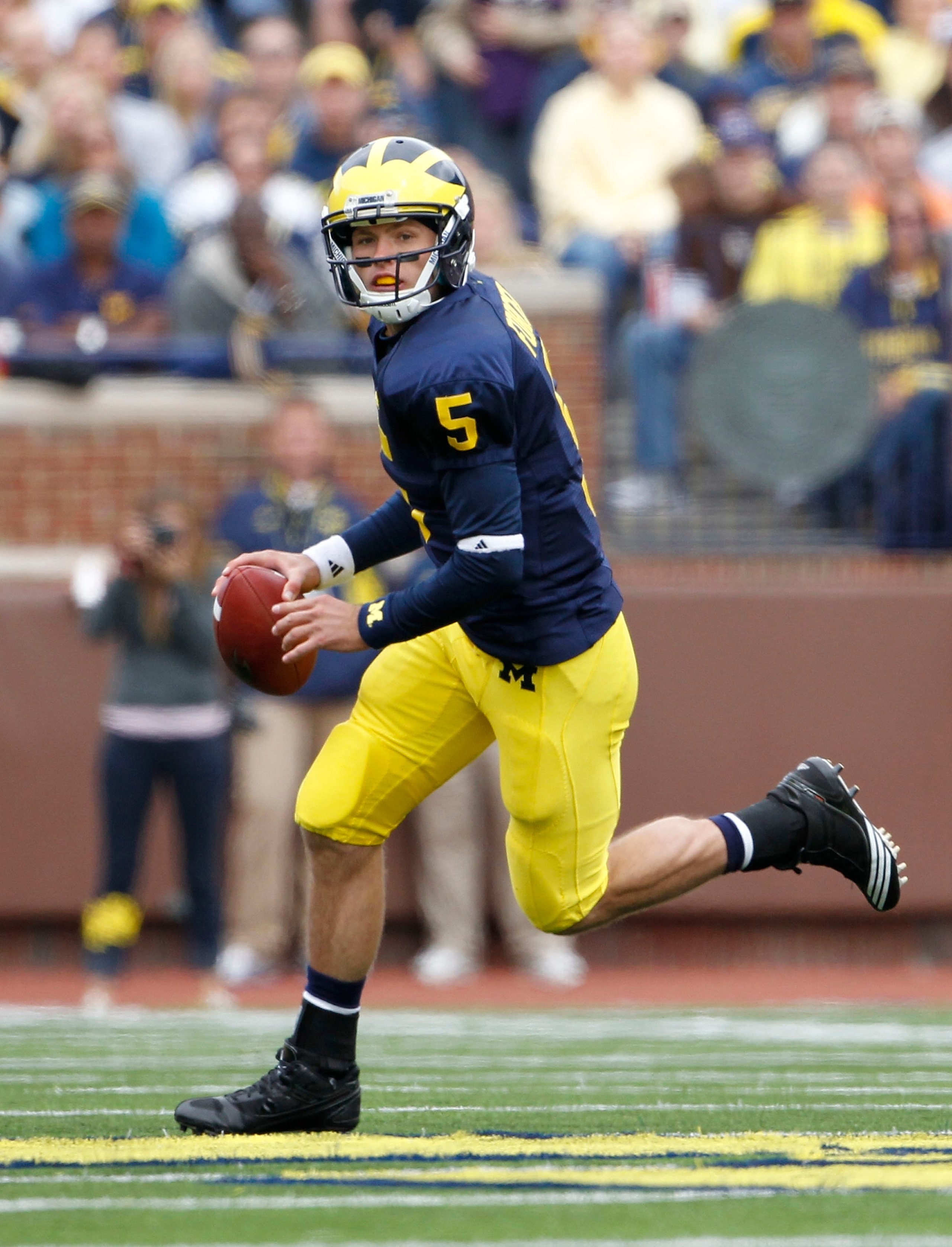 ANN ARBOR, MI - SEPTEMBER 25:  Tate Forcier #5 of the Michigan Wolverines roles out to pass during the second quarter of the game against Bowling Green on September 25, 2010 at Michigan Stadium in Ann Arbor, Michigan.  (Photo by Leon Halip/Getty Images)