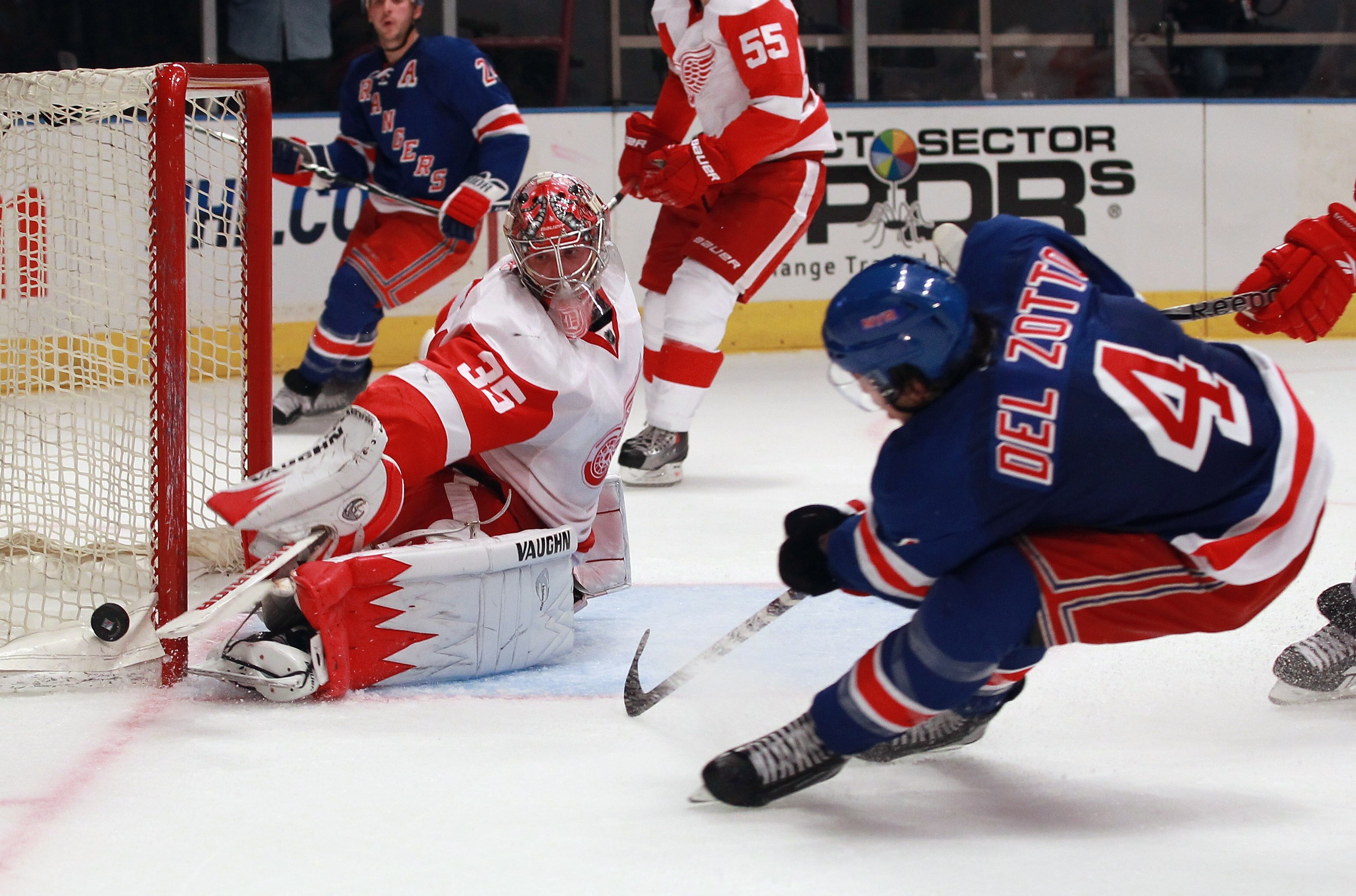 NEW YORK - SEPTEMBER 29: Jimmy Howard #35 of the Detroit Red Wings makes the stick save as Michael Del Zotto #4 of the New York Rangers looks for a rebound at Madison Square Garden on September 29, 2010 in New York City.  (Photo by Bruce Bennett/Getty Ima