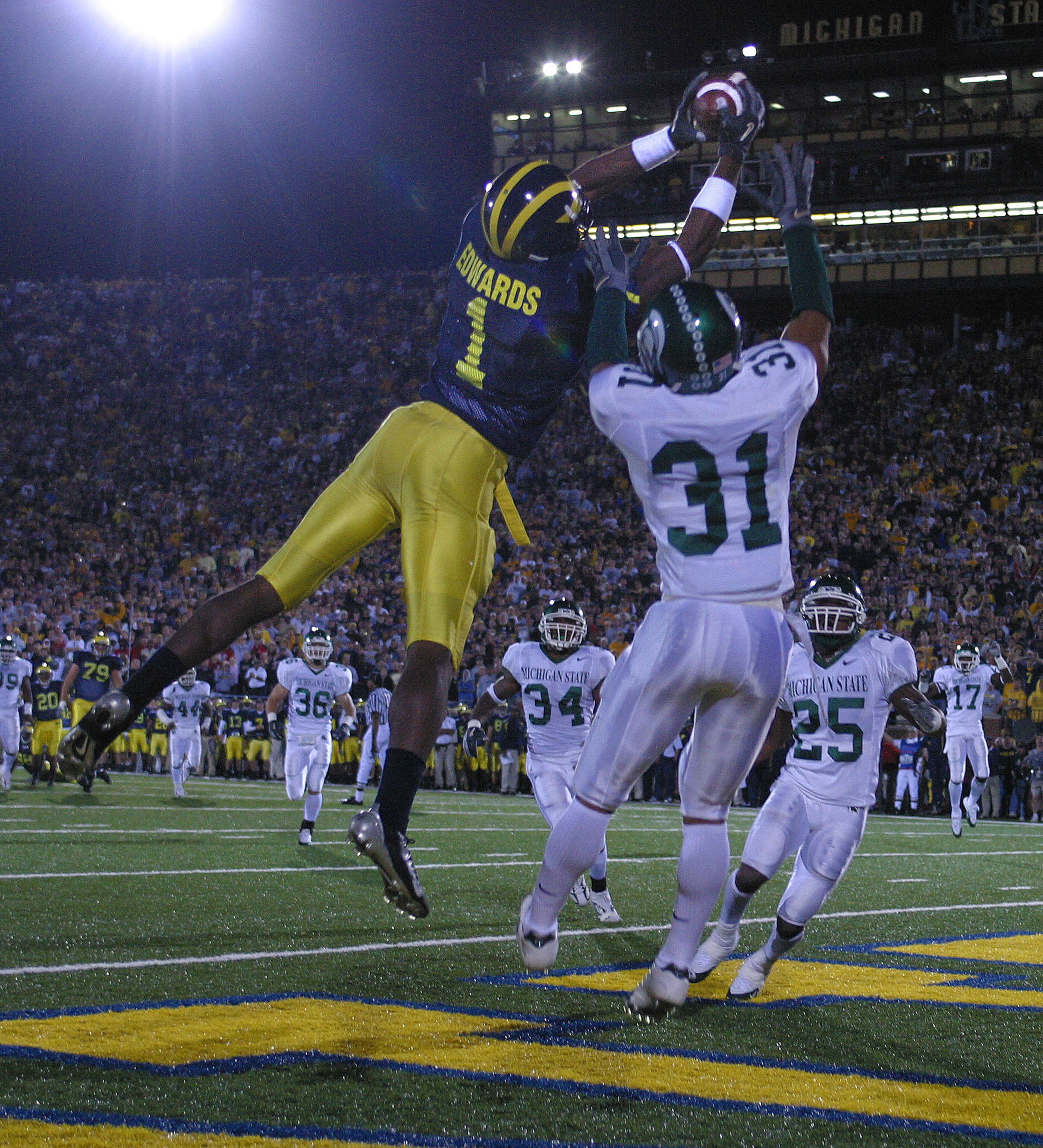 ANN ARBOR - October 30: Wide receiver Braylon Edwards #1 of Michigan catches a touchdown pass defended by Jaren Hayes #31 of Michigan State at Michigan Stadium on October 30, 2004 in Ann Arbor, Michigan. The Michigan Wolverines defeated the Michigan Sta ANN ARBOR - October 30: Wide receiver Braylon Edwards #1 of Michigan catches a touchdown pass defended by Jaren Hayes #31 of Michigan State at Michigan Stadium on October 30, 2004 in Ann Arbor, Michigan. The Michigan Wolverines defeated the Michigan Sta