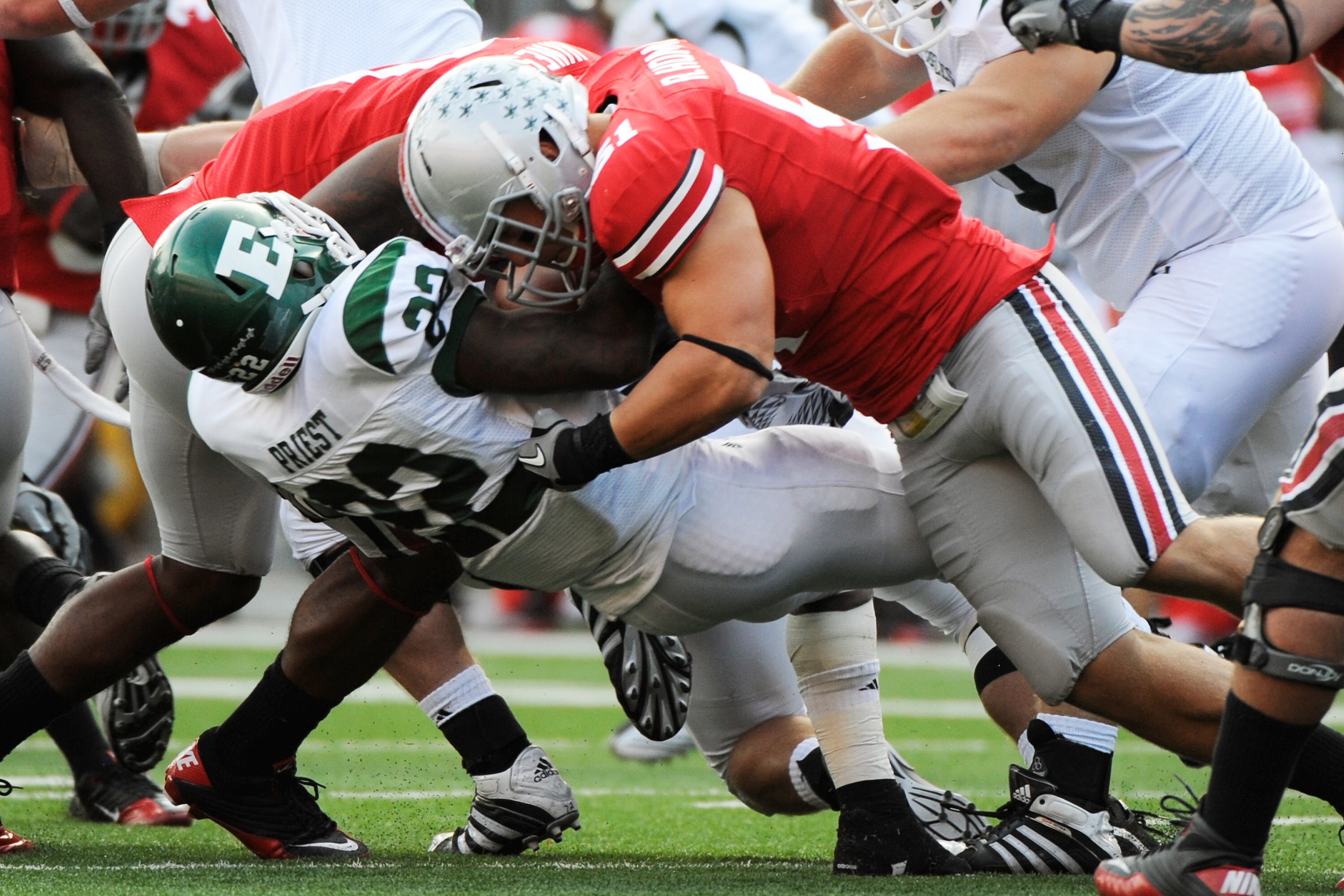 COLUMBUS, OH - SEPTEMBER 25:  Ross Homan #51 of the Ohio State Buckeyes tackles Dwayne Priest #22 of the Eastern Michigan Eagles at Ohio Stadium on September 25, 2010 in Columbus, Ohio.  (Photo by Jamie Sabau/Getty Images)