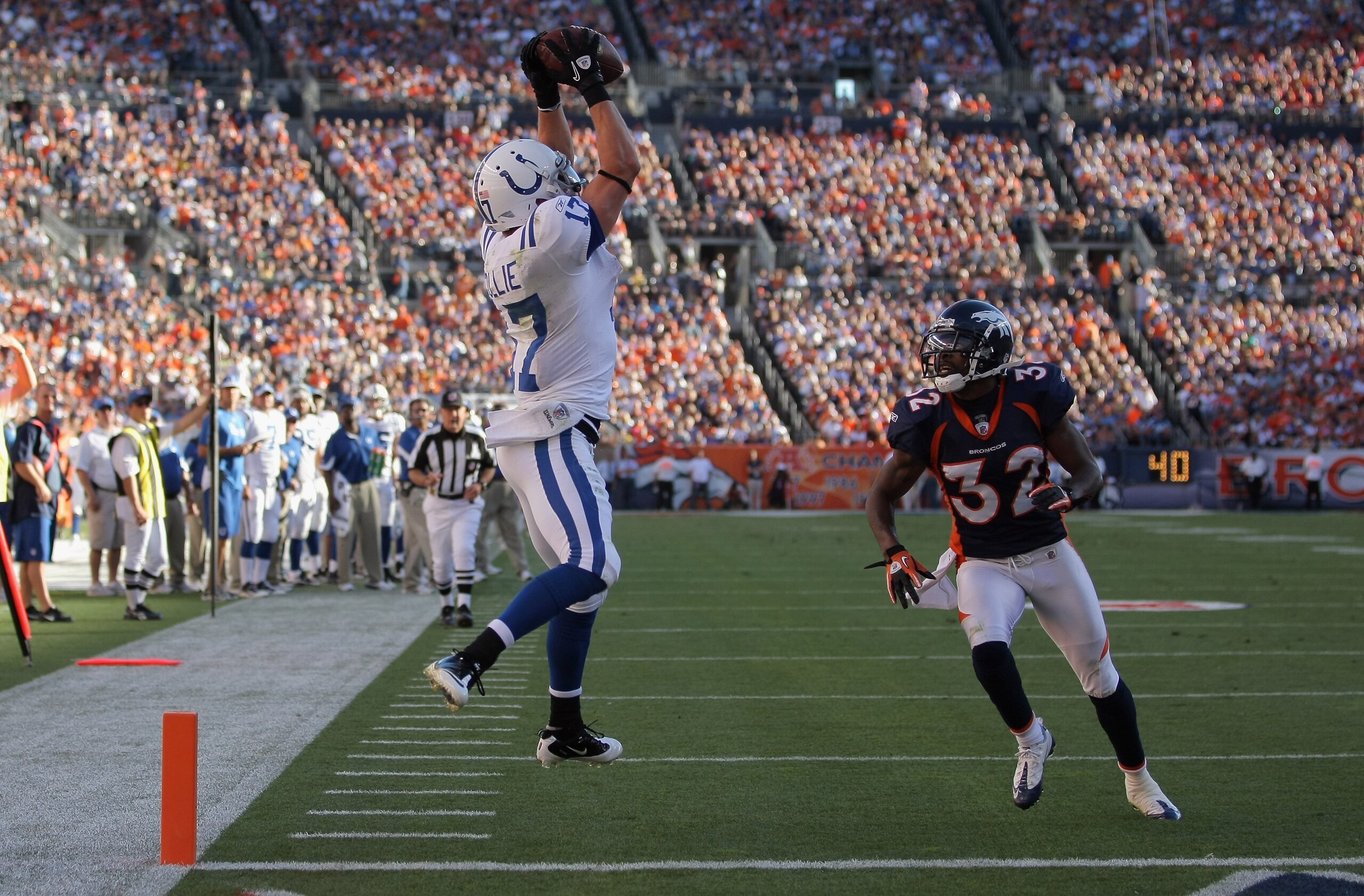 DENVER - SEPTEMBER 26:  Wide receiver Austin Collie #17 of the Indianapolis Colts makes a 23 yard touchdown reception in the fourth quarter as Perrish Cox #32 of the Denver Broncos defends at INVESCO Field at Mile High on September 26, 2010 in Denver, Col