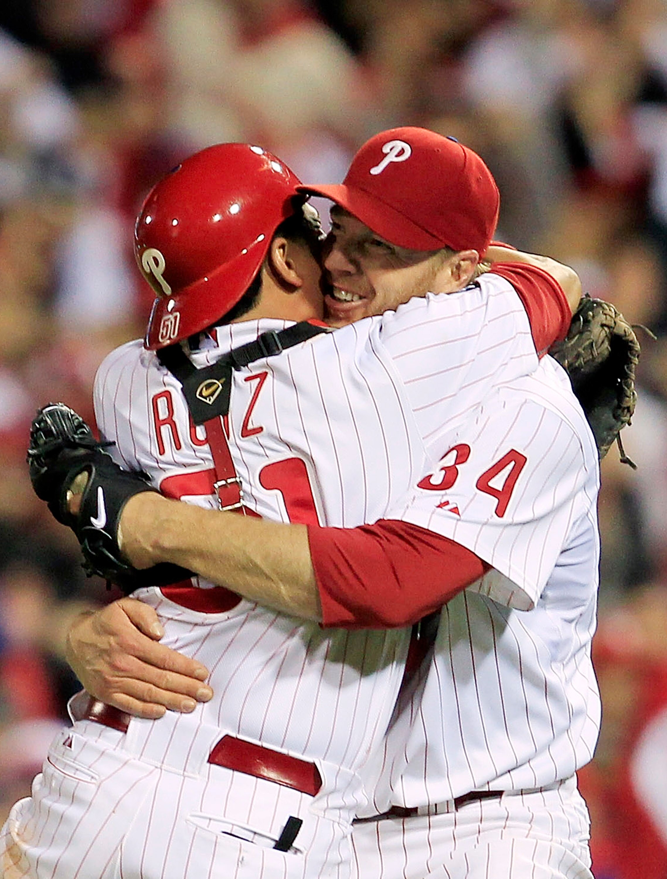 PHILADELPHIA - OCTOBER 06: (EDITORS NOTE: Alternate Crop) Roy Halladay #34 and Carlos Ruiz #51 of the Philadelphia Phillies celebrate Halladay's no-hitter and the win in Game 1 of the NLDS against the Cincinnati Reds at Citizens Bank Park on October 6, 20