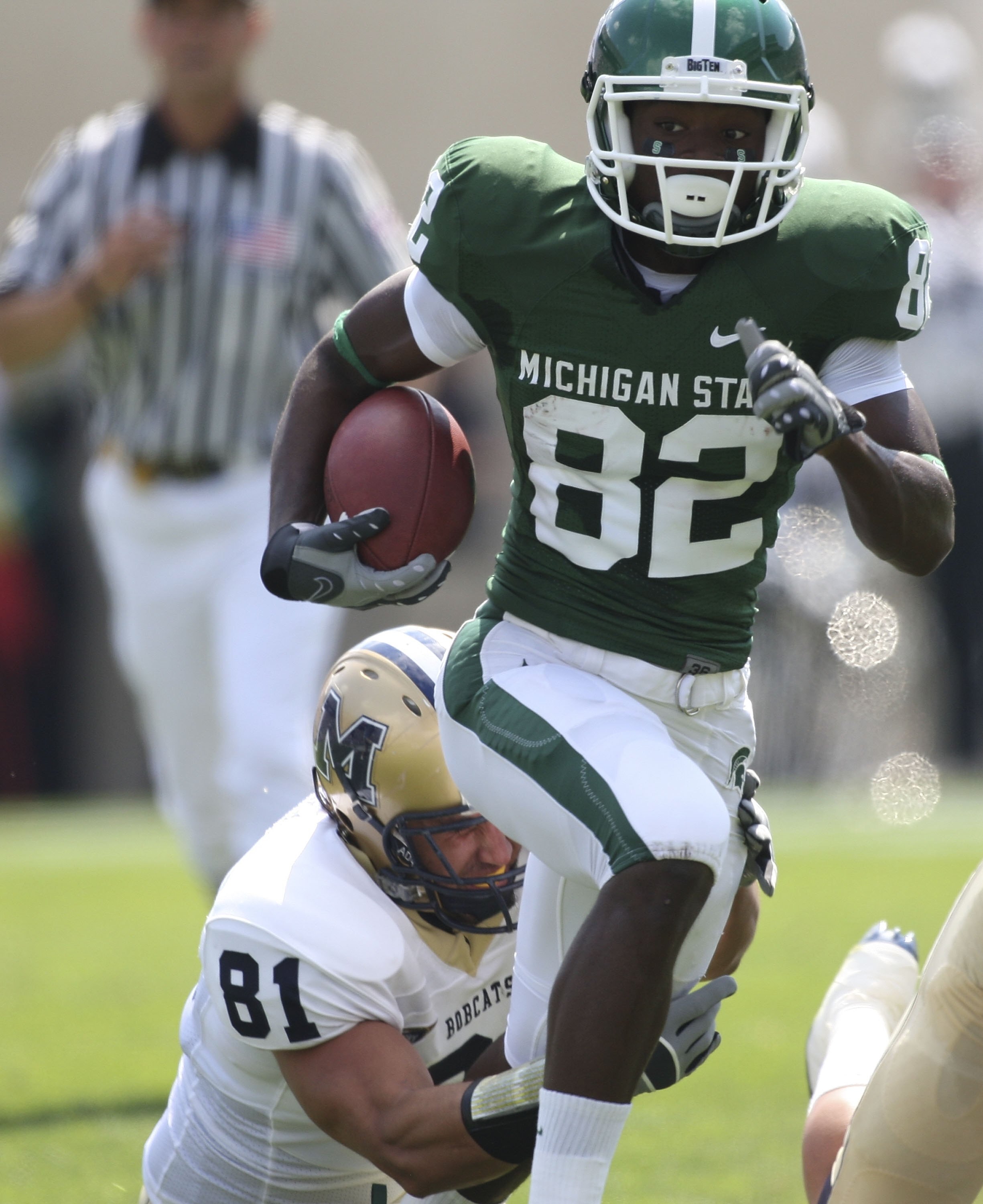 EAST LANSING, MI - SEPTEMBER 05: Wide receiver Keshawn Martin #82 of the Michigan State Spartans runs for a first down in the second quarter as Kyle Begger #81 of Montana State attempts to make the stop on September 5, 2009 at Spartan Stadium in East Lans
