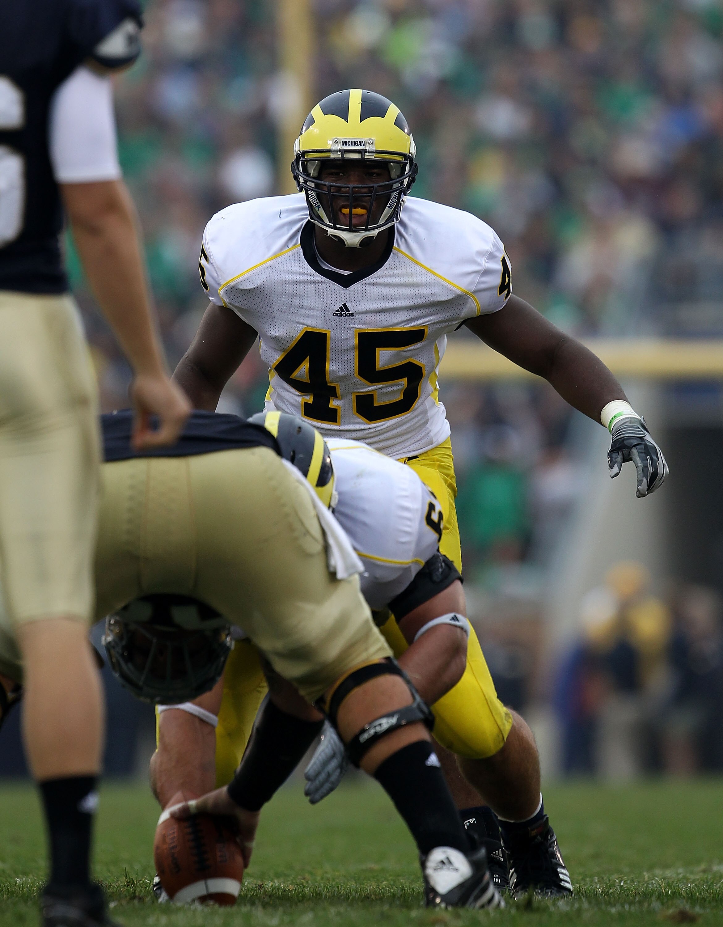 SOUTH BEND, IN - SEPTEMBER 11: Obi Ezeh #45 of the Michigan Wolverines awaits the start of play against the Notre Dame Fighting Irish at Notre Dame Stadium on September 11, 2010 in South Bend, Indiana. Michigan defeated Notre Dame 28-24.  (Photo by Jonath