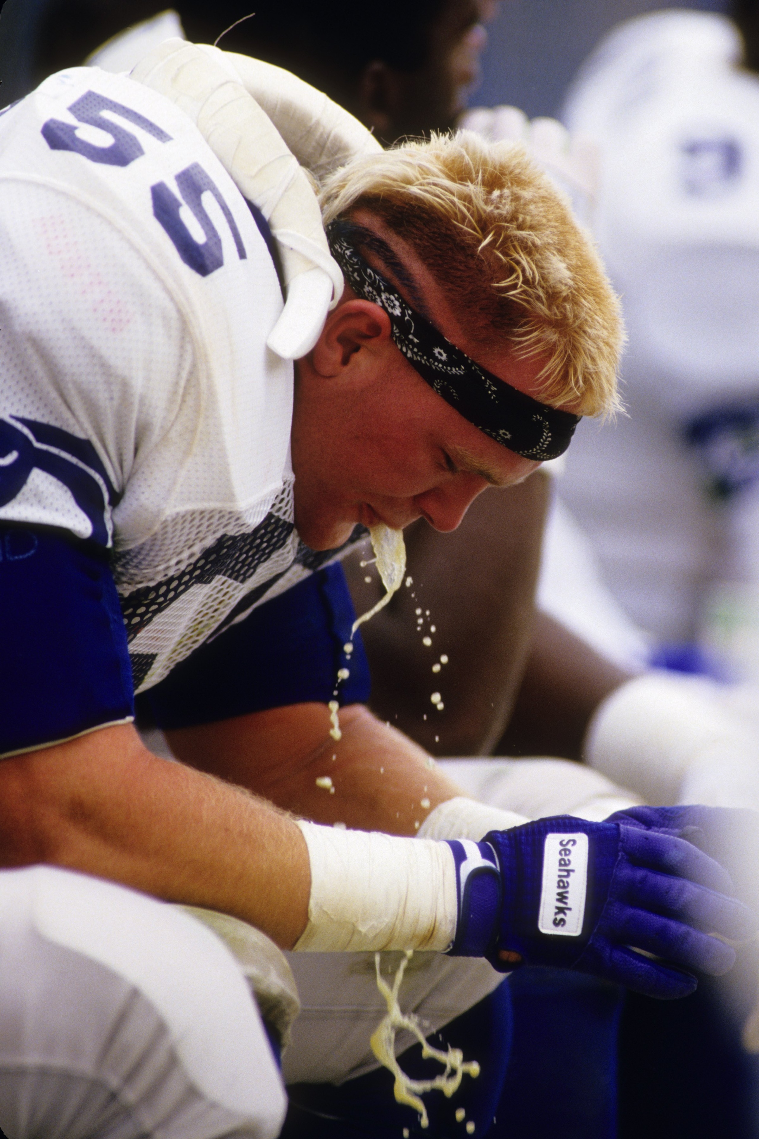 DENVER, CO - SEPTEMBER 13:  Linebacker Brian Bosworth #55 of the Seattle Seahawks drinks water on the sideline during the game against the Denver Broncos at Mile High Staduim on September 13, 1987 in Denver, Colorado.  The Broncos won 40-17. (Photo by Geo