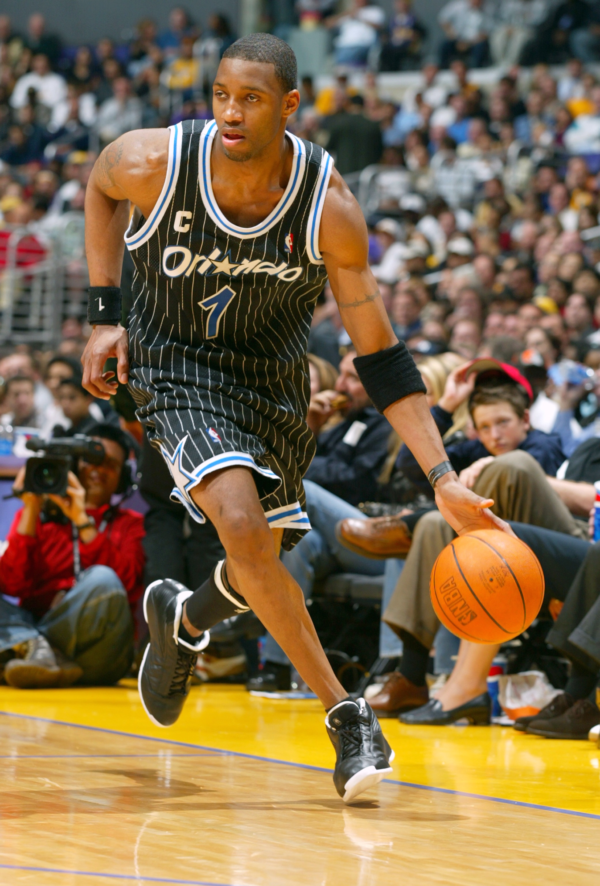 LOS ANGELES - MARCH 15:  Tracy McGrady #1 of the Orlando Magic drives upcourt during the game against the Los Angeles Lakers at Staples Center on March 15, 2004 in Los Angeles, California.  The Lakers won 113-110.   NOTE TO USER: User expressly acknowledg