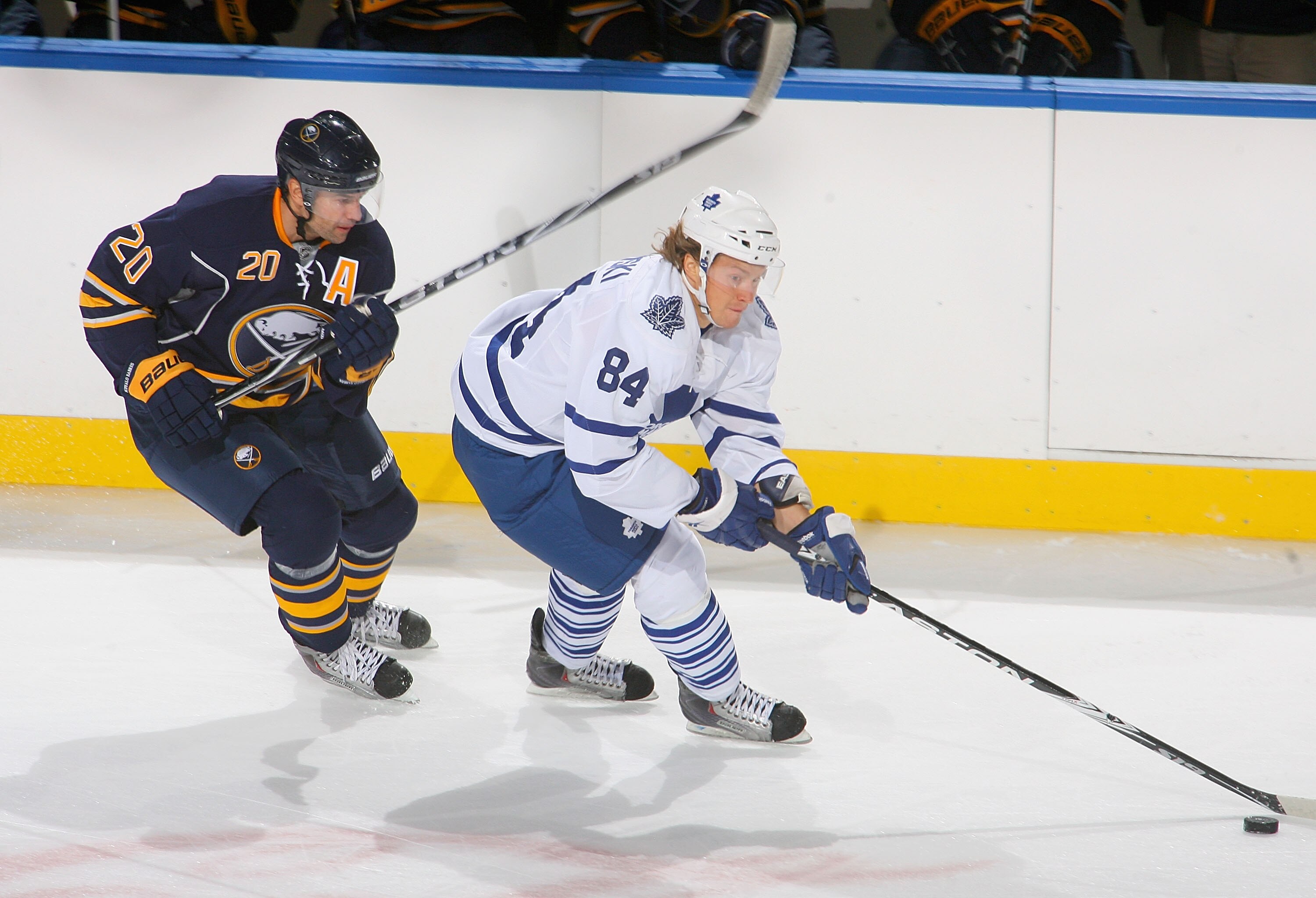 BUFFALO, NY - SEPTEMBER 25: Mikhail Grabovski #84 of the Toronto Maple Leafs skates ahead of Rob Niedermayer #20 of the Buffalo Sabres  at HSBC Arena on September 25, 2010 in Buffalo, New York.  (Photo by Rick Stewart/Getty Images)