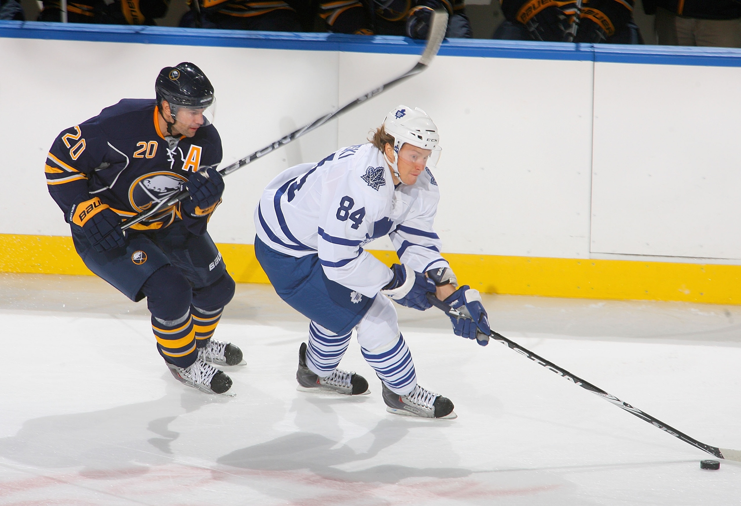 BUFFALO, NY - SEPTEMBER 25: Mikhail Grabovski #84 of the Toronto Maple Leafs skates ahead of Rob Niedermayer #20 of the Buffalo Sabres  at HSBC Arena on September 25, 2010 in Buffalo, New York.  (Photo by Rick Stewart/Getty Images)